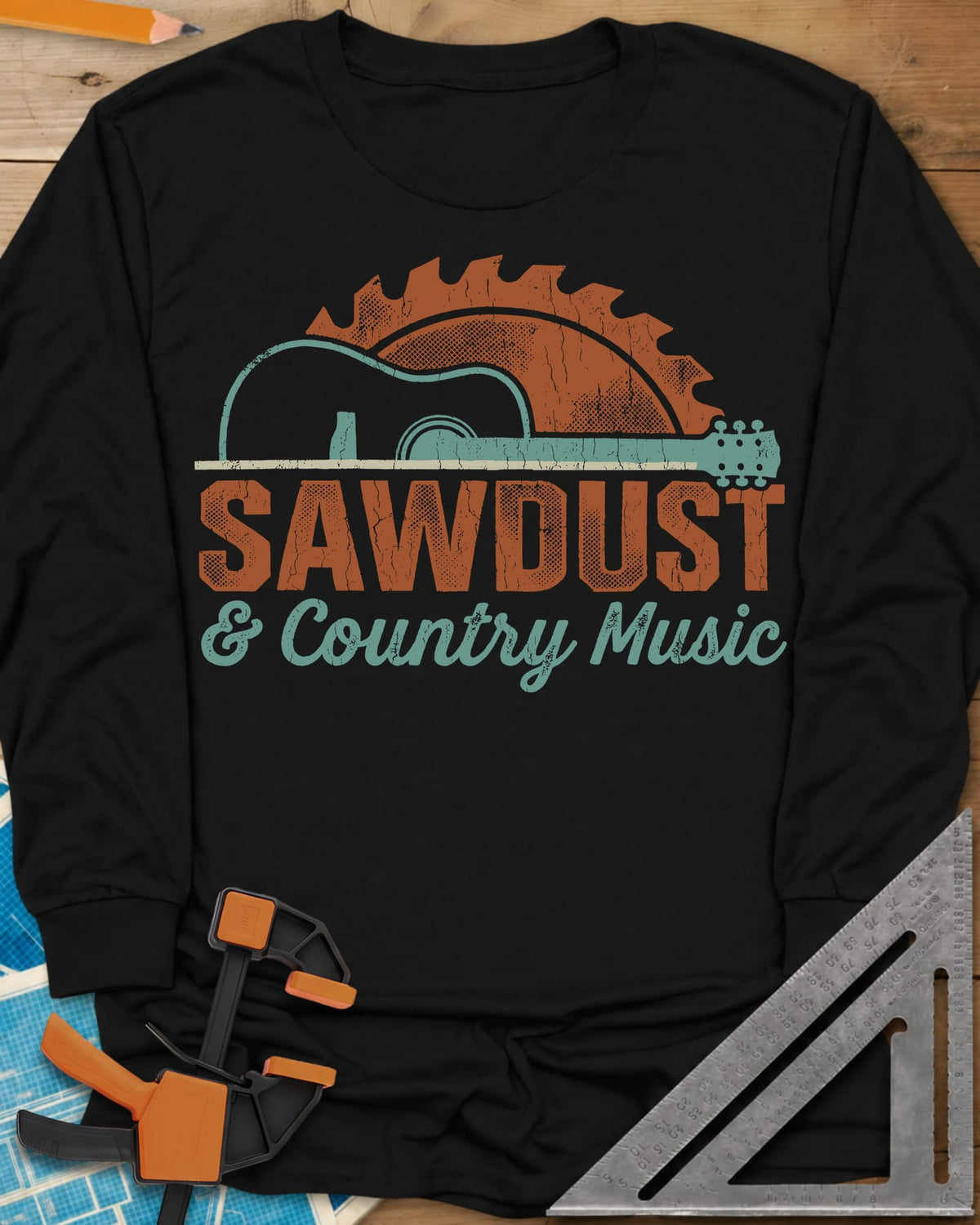 Sawdust And Country Music long sleeve shirt in Black, an acoustic guitar in front of a rising saw blade