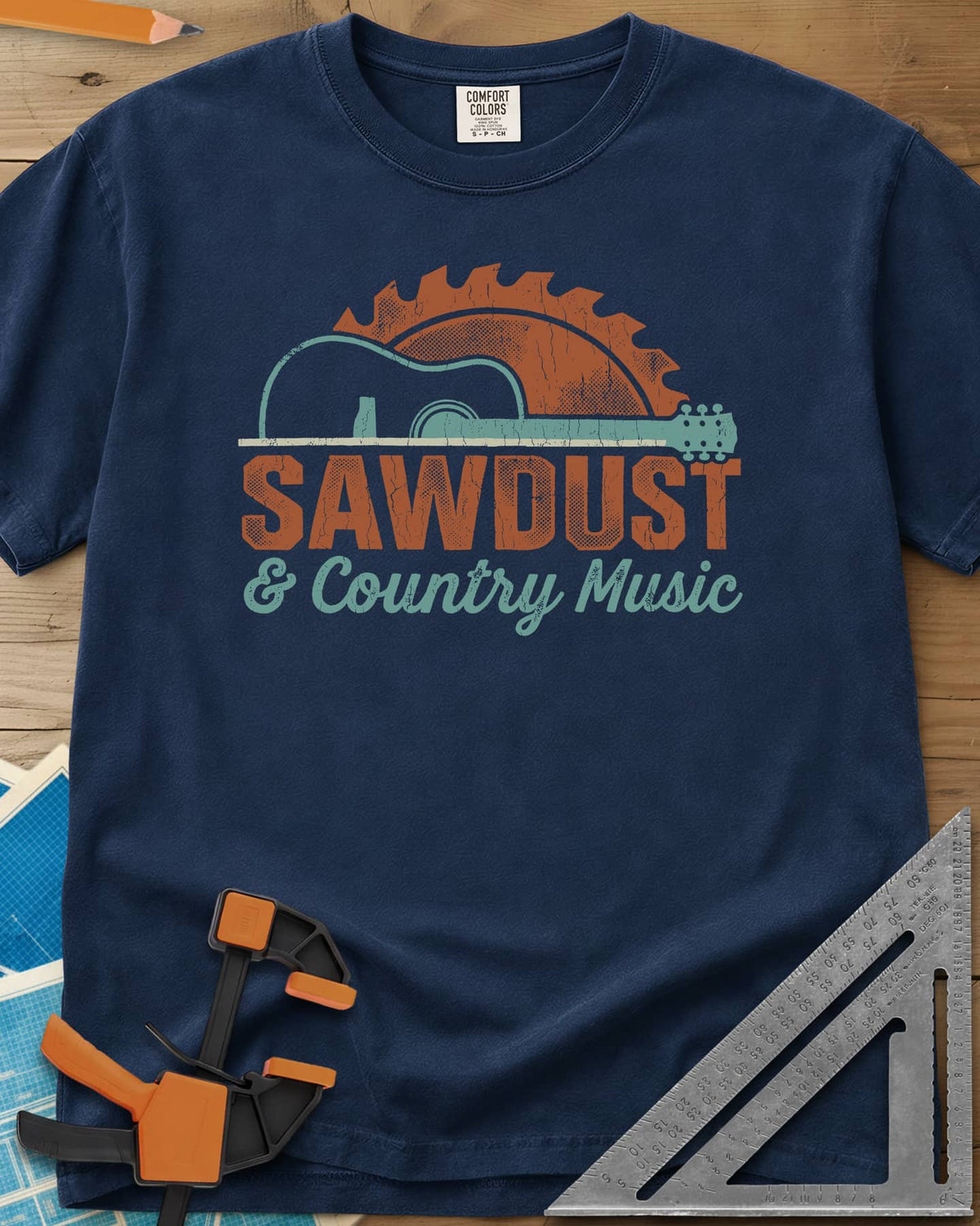Sawdust And Country Music heavyweight tee in Navy, an acoustic guitar in front of a rising saw blade