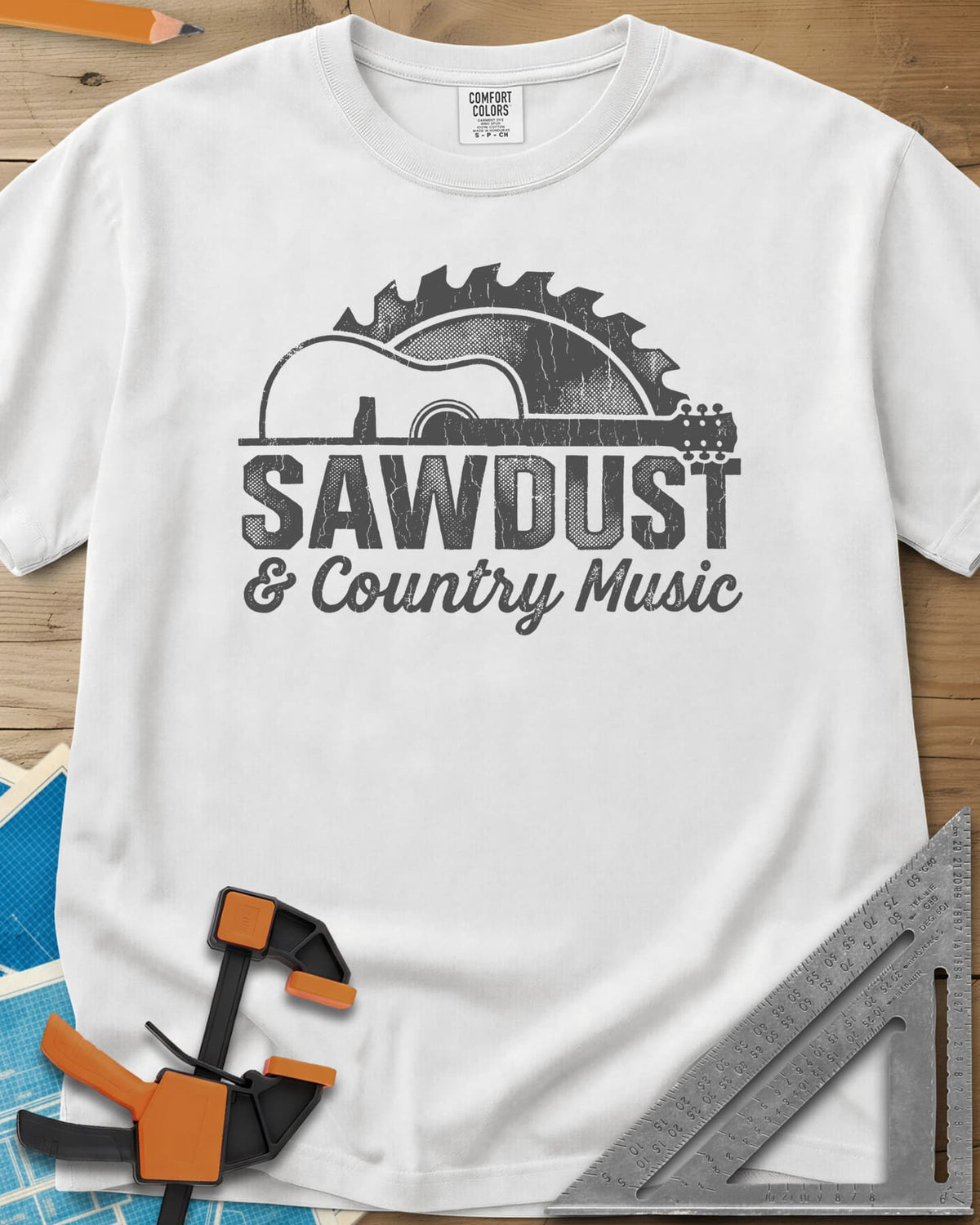Sawdust And Country Music heavyweight tee in White, an acoustic guitar in front of a rising saw blade
