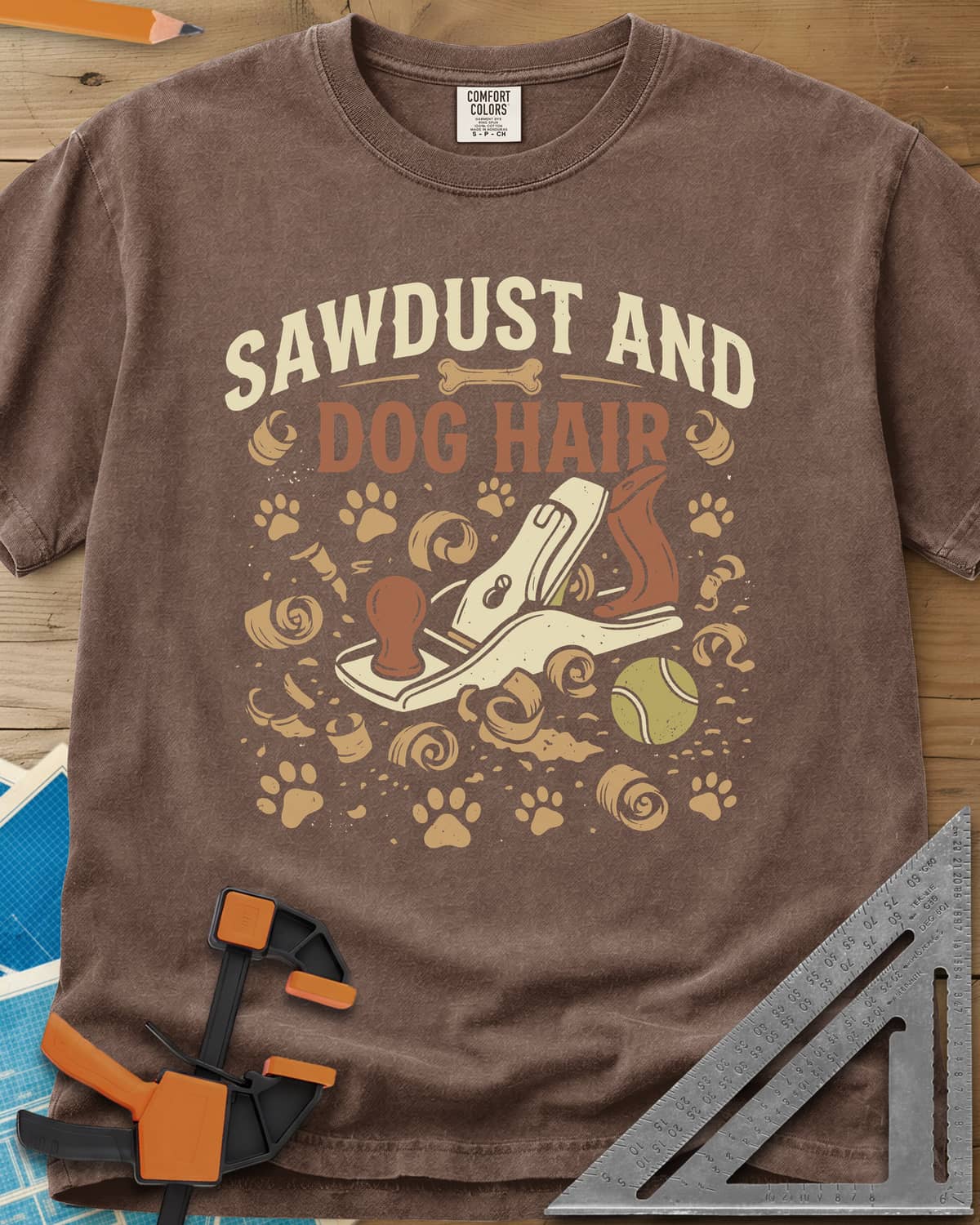 Sawdust And Dog Hair heavyweight tee in Espresso, hand plane, wood curls, paw prints and a tennis ball