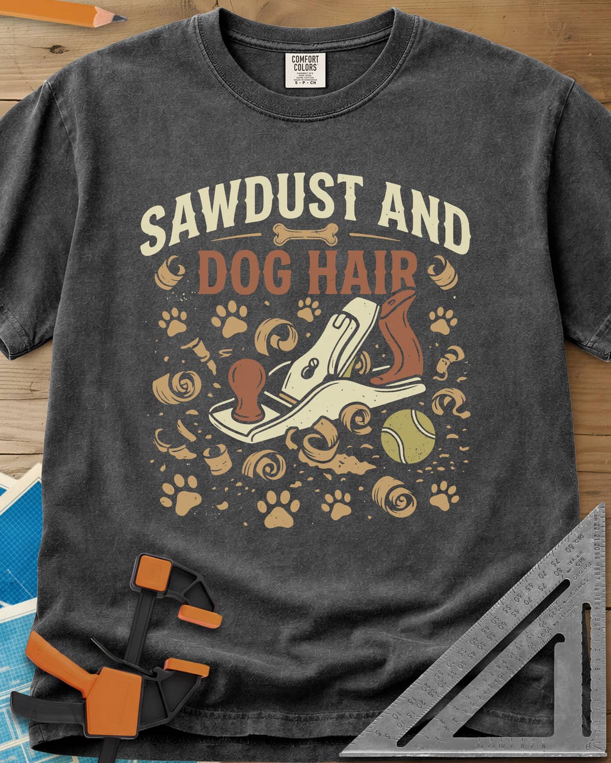 Sawdust And Dog Hair heavyweight tee in Pepper, hand plane, wood curls, paw prints and a tennis ball