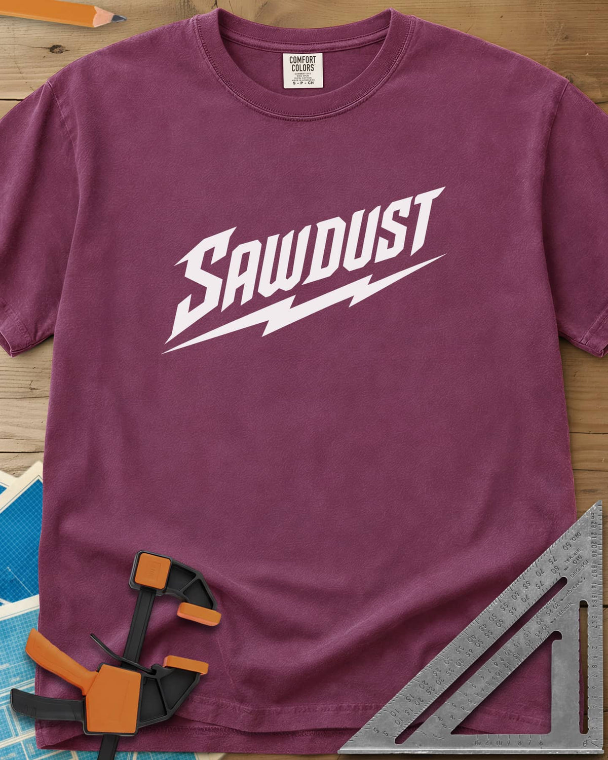 Sawdust Bolt heavyweight tee in Berry, bold slanted SAWDUST lettering with a lightning bolt underneath