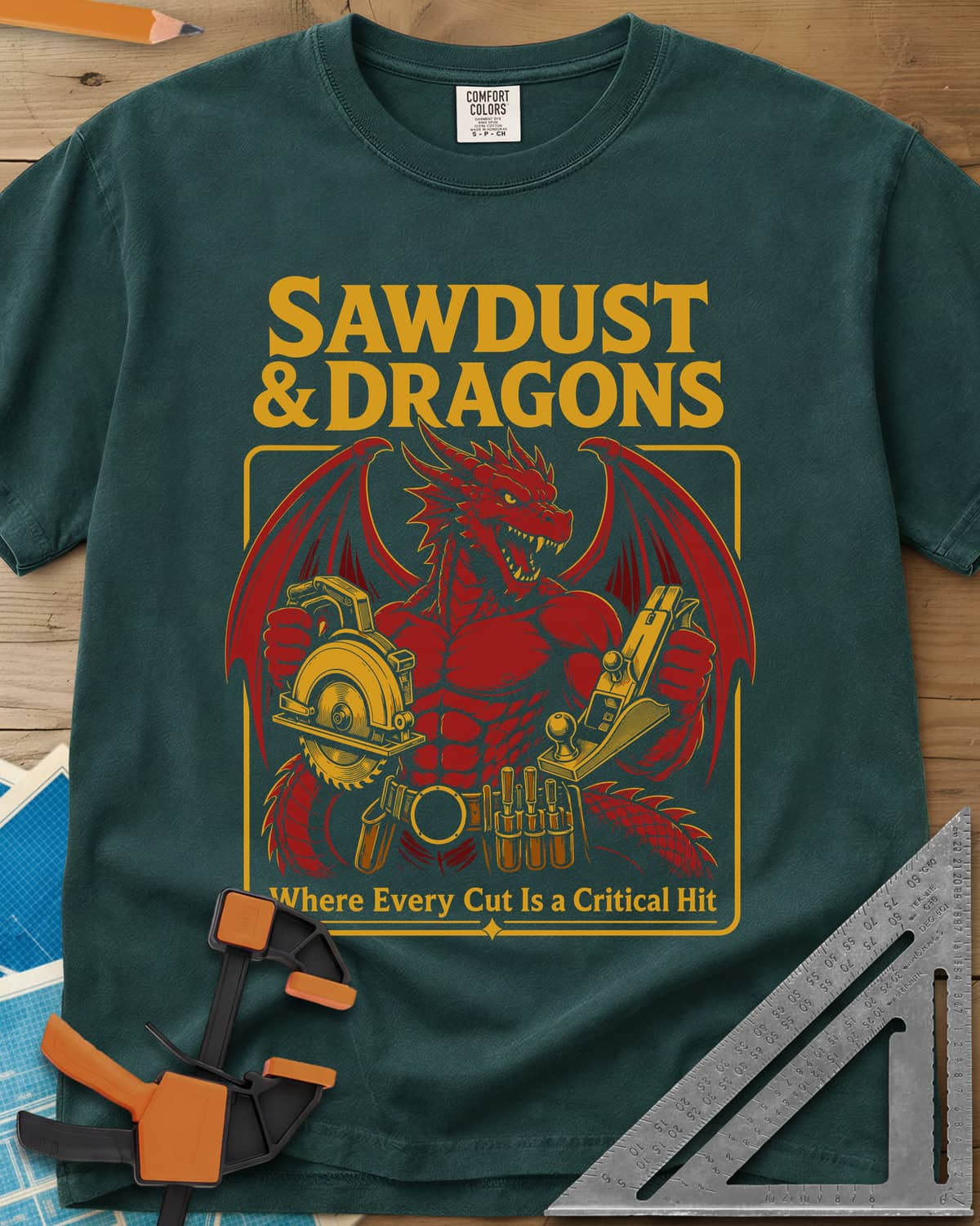 Sawdust & Dragons heavyweight tee in Blue Spruce, red dragon in a tool belt holding a circular saw and a hand plane