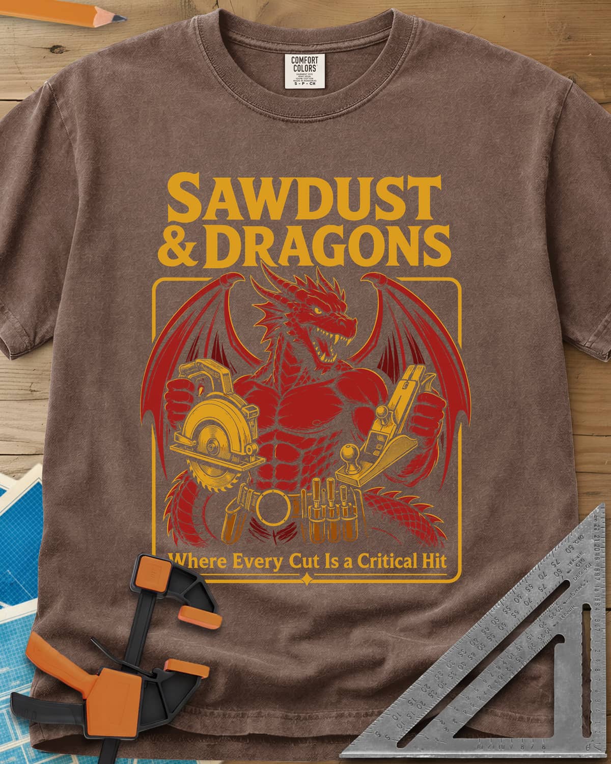 Sawdust & Dragons heavyweight tee in Espresso, red dragon in a tool belt holding a circular saw and a hand plane