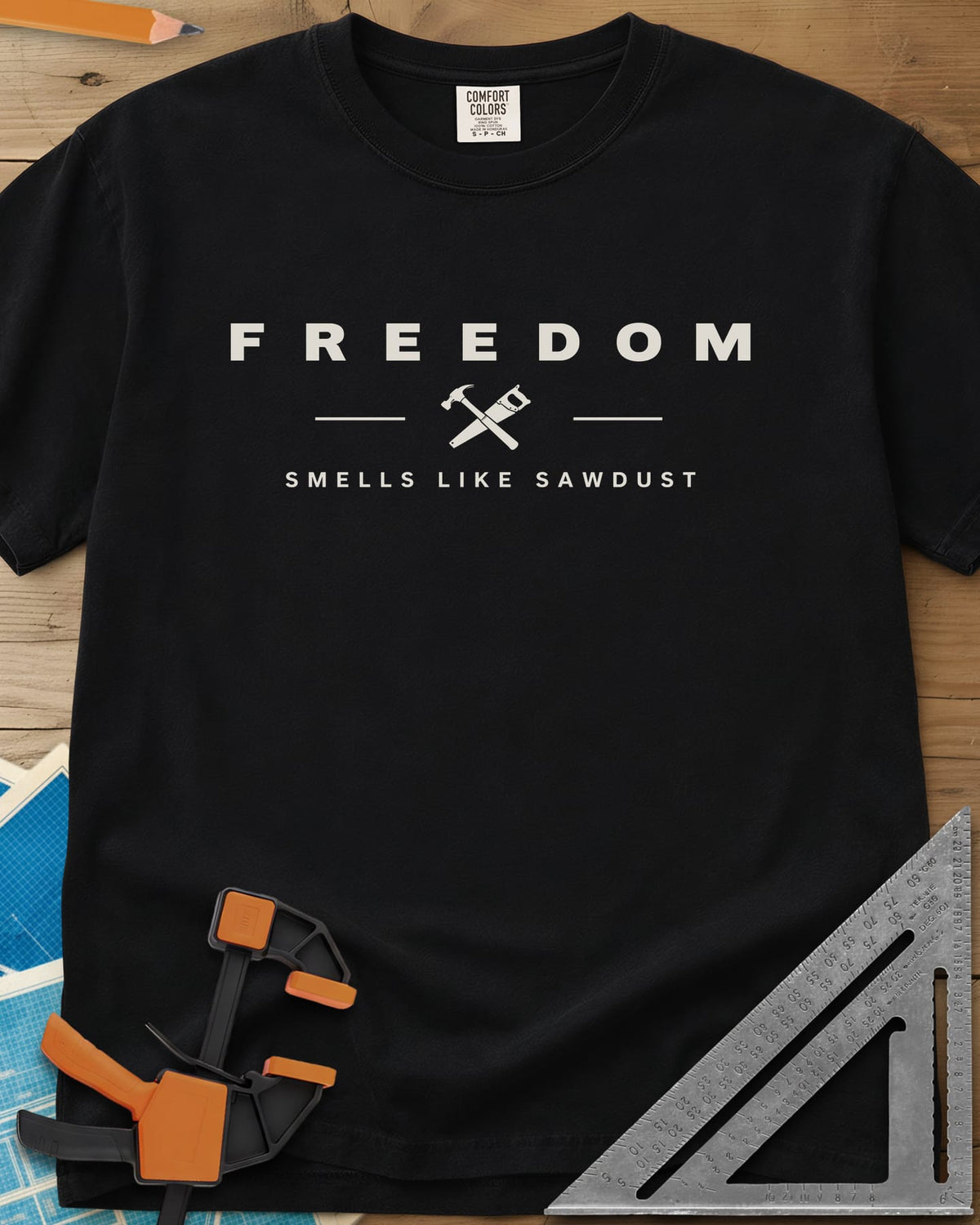 Sawdust Freedom heavyweight tee in Black, crossed hammer and saw icon between two lines, wide-spaced lettering