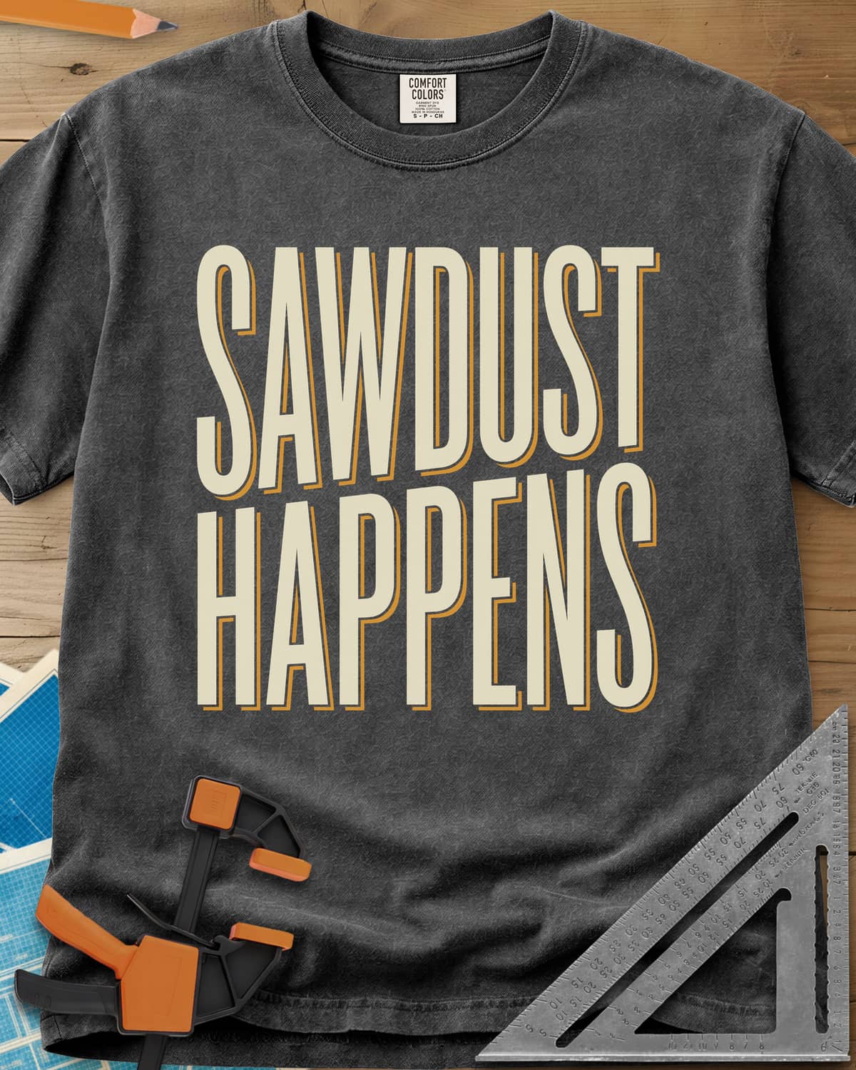 Sawdust Happens heavyweight tee in Pepper, tall condensed block letters with an offset shadow