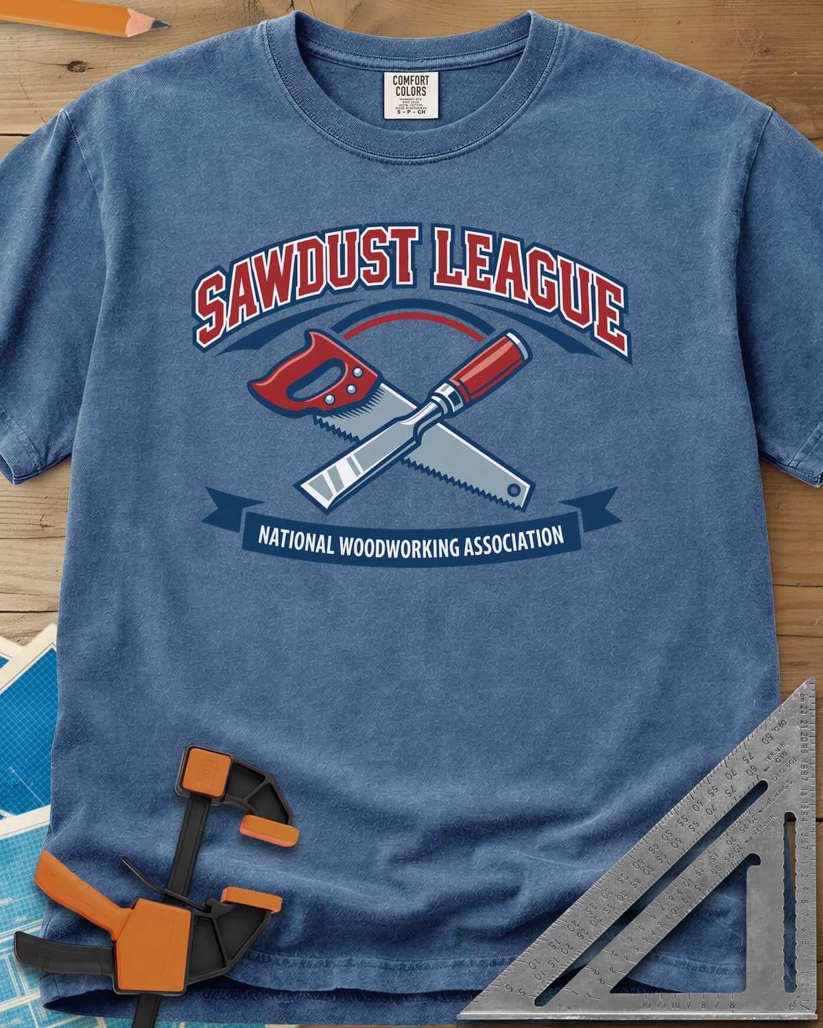 Sawdust League heavyweight tee in Blue Jean, varsity badge with a crossed hand saw and chisel and a ribbon