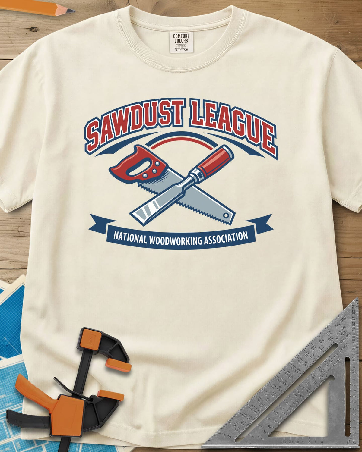 Sawdust League heavyweight tee in Ivory, varsity badge with a crossed hand saw and chisel and a ribbon