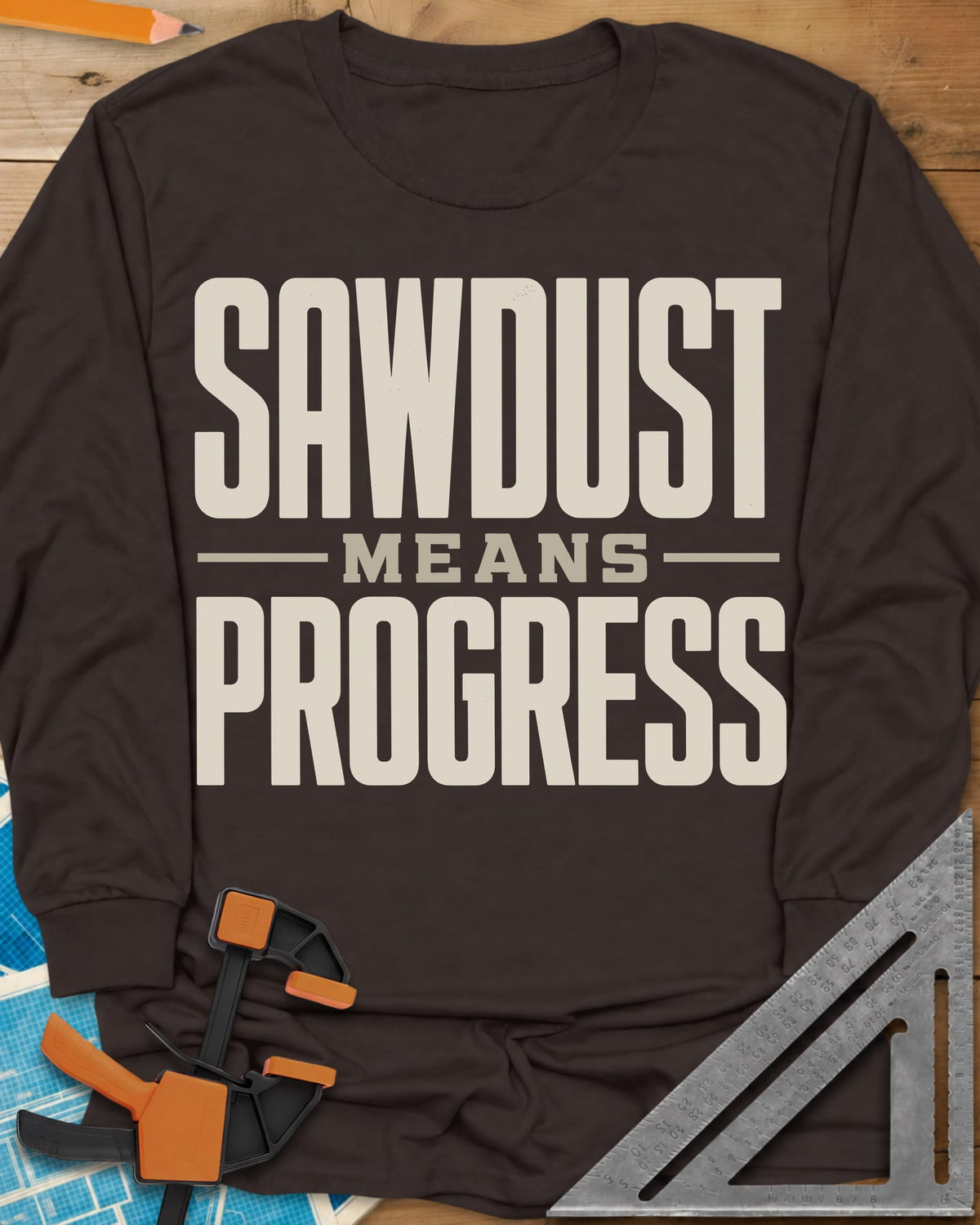 Sawdust Progress long sleeve shirt in Dark Chocolate, tall block letters with a small MEANS set between two rules