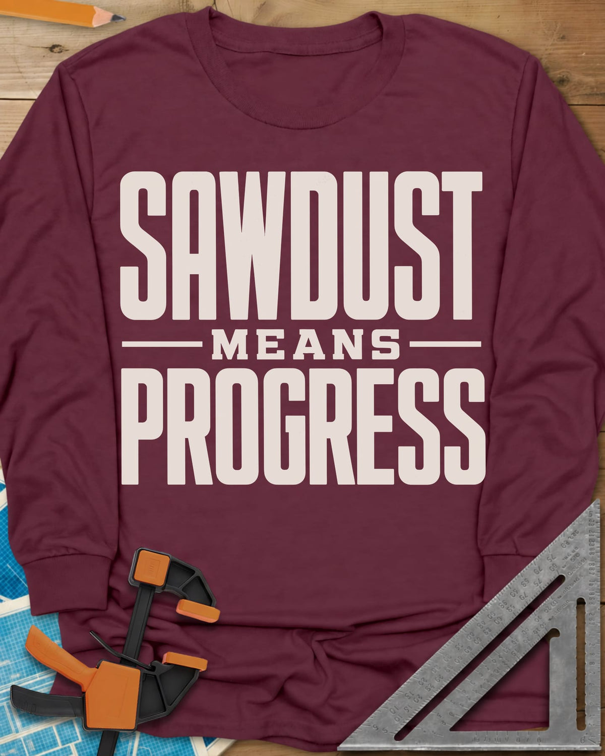 Sawdust Progress long sleeve shirt in Maroon, tall block letters with a small MEANS set between two rules