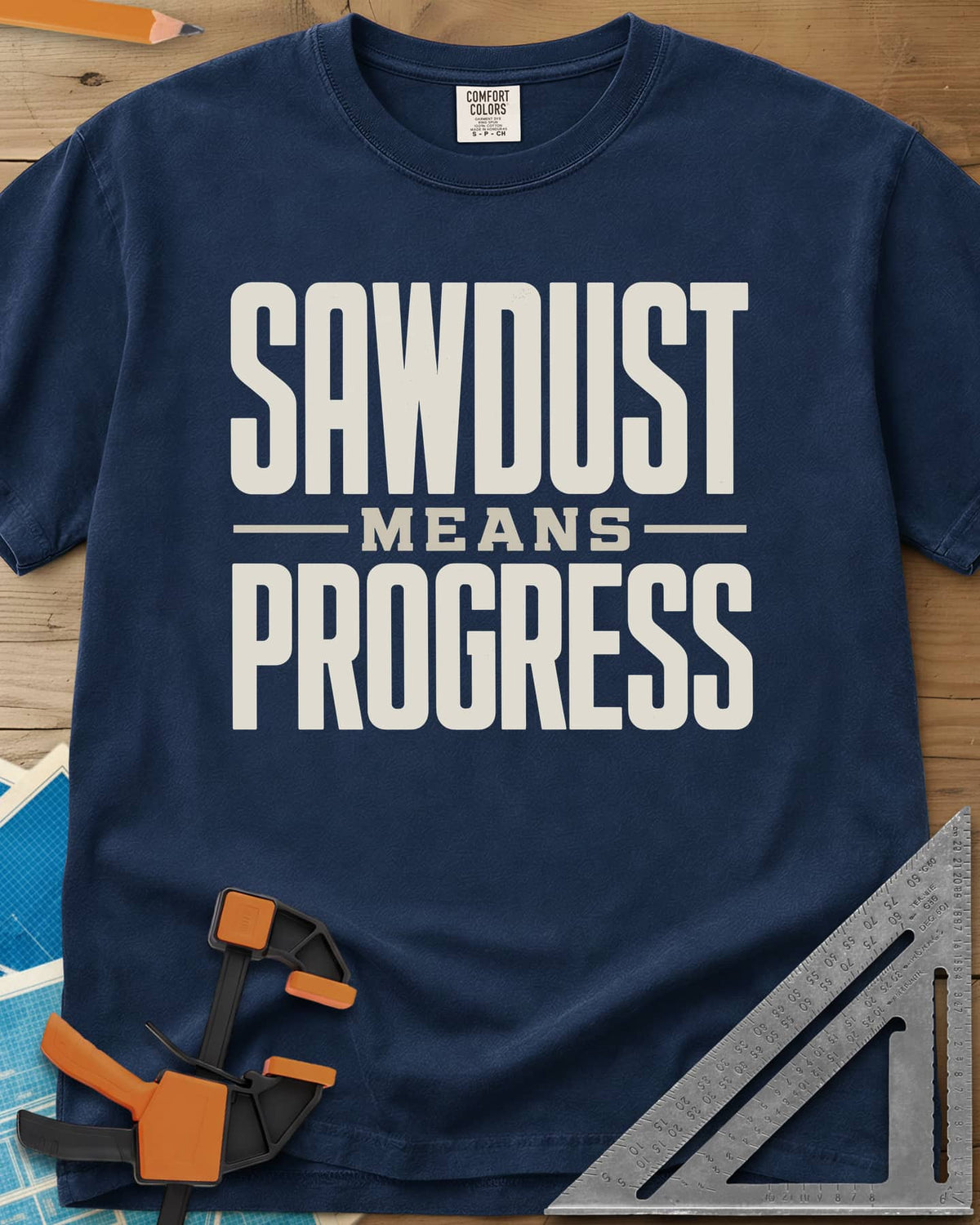 Sawdust Progress heavyweight tee in Navy, tall block letters with a small MEANS set between two rules