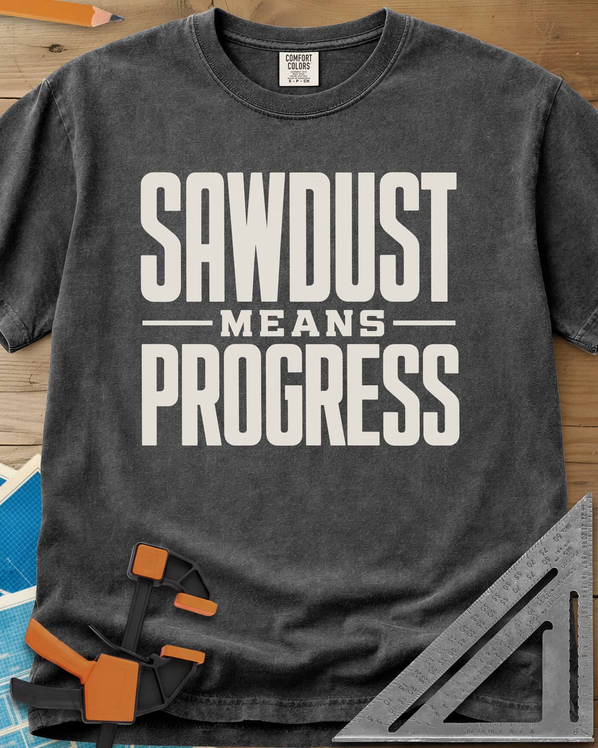 Sawdust Progress heavyweight tee in Pepper, tall block letters with a small MEANS set between two rules