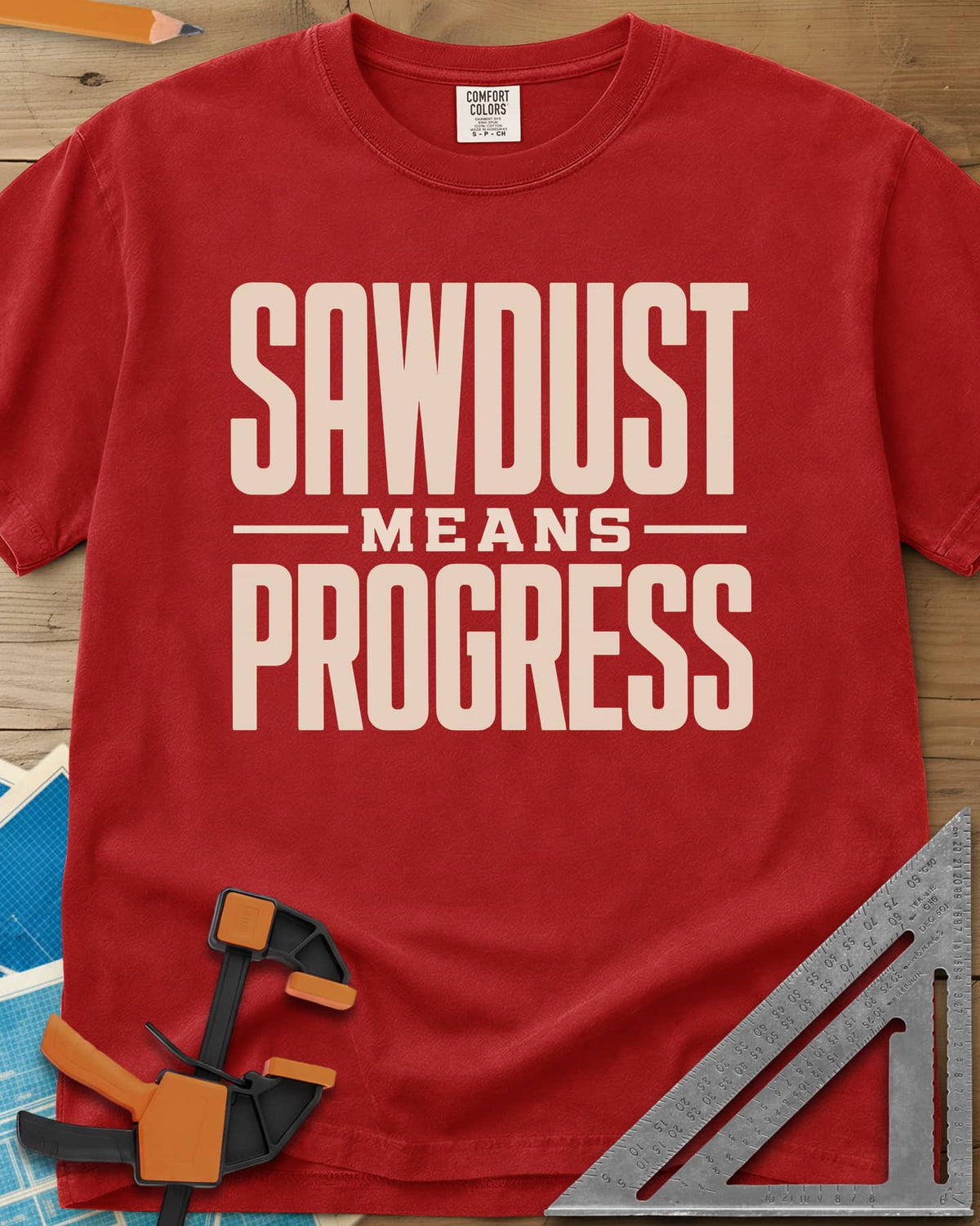 Sawdust Progress heavyweight tee in Red, tall block letters with a small MEANS set between two rules