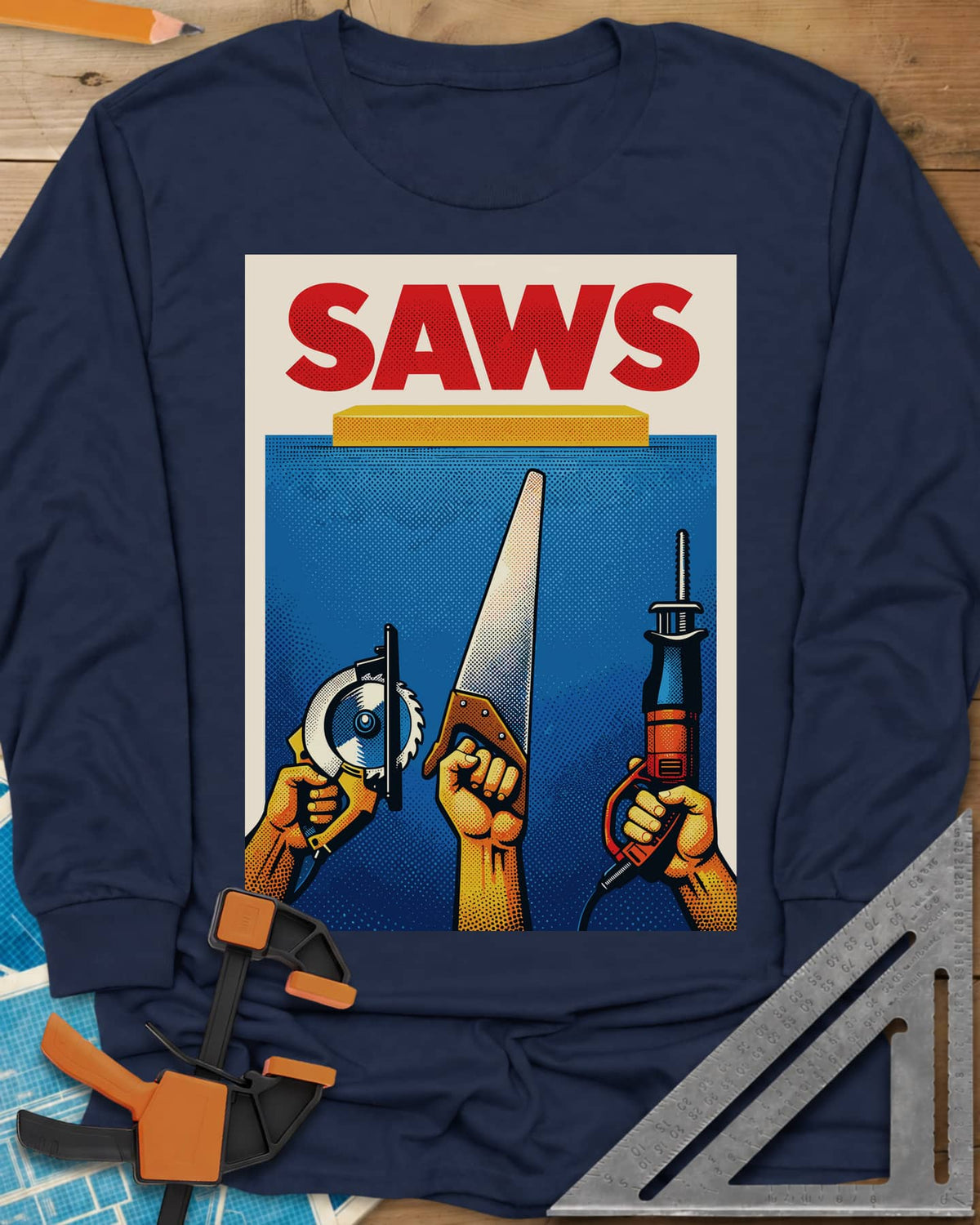 Saws Tool Pride long sleeve shirt in Navy, three hands raising a circular saw, handsaw and reciprocating saw