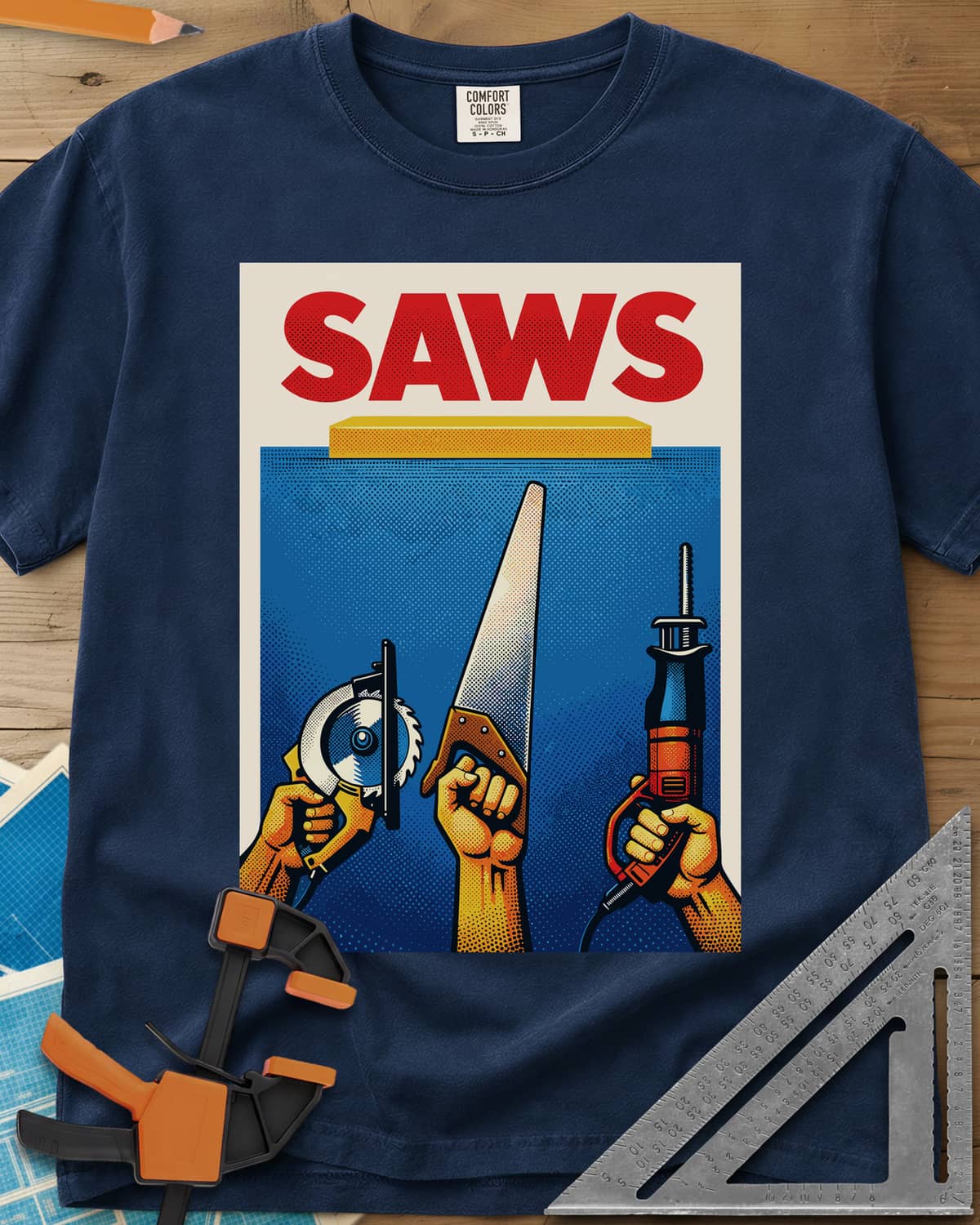 Saws Tool Pride heavyweight tee in Navy, three hands raising a circular saw, handsaw and reciprocating saw
