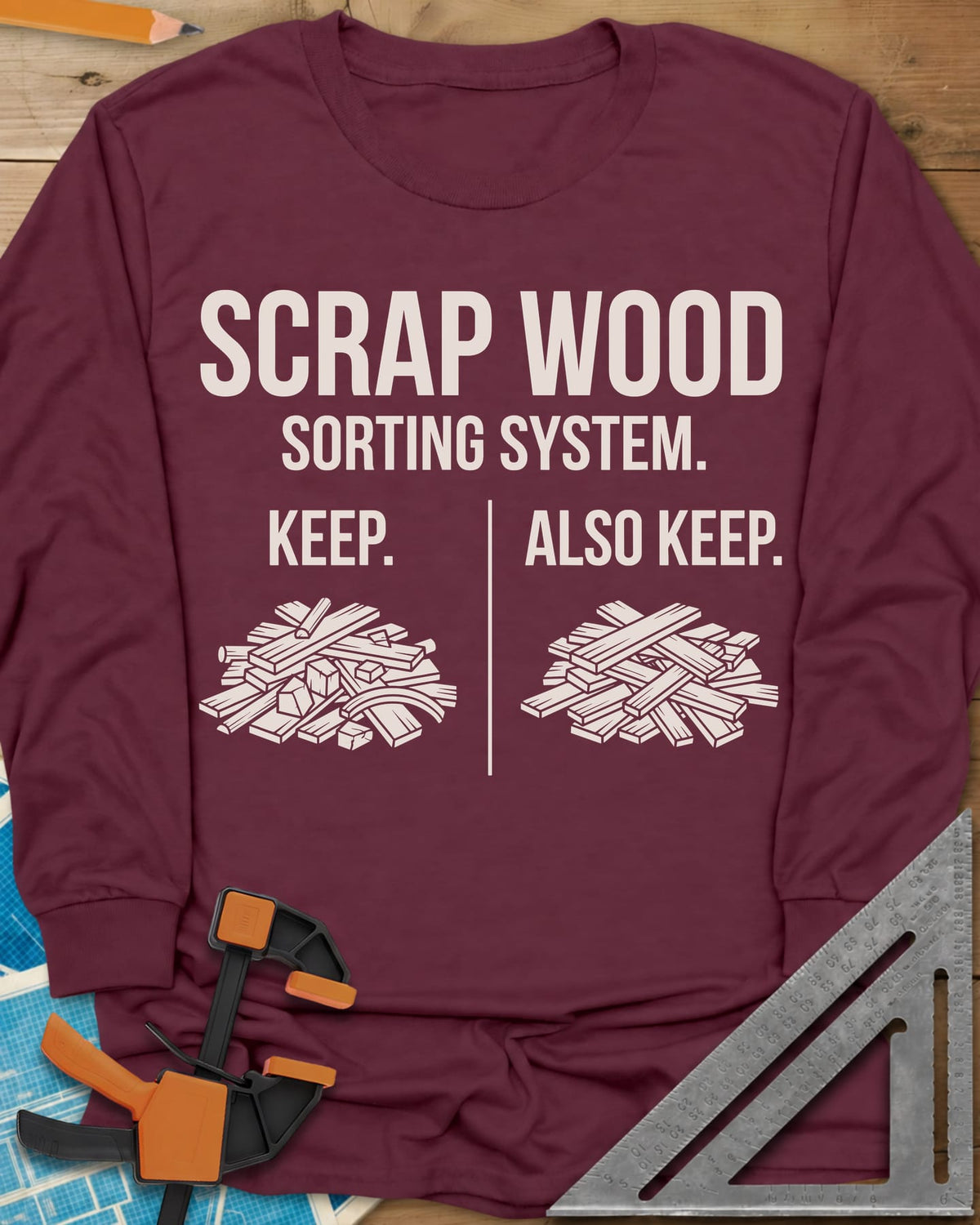 Scrap Wood Sorting System long sleeve shirt in Maroon, two piles of scrap lumber split by a thin vertical line