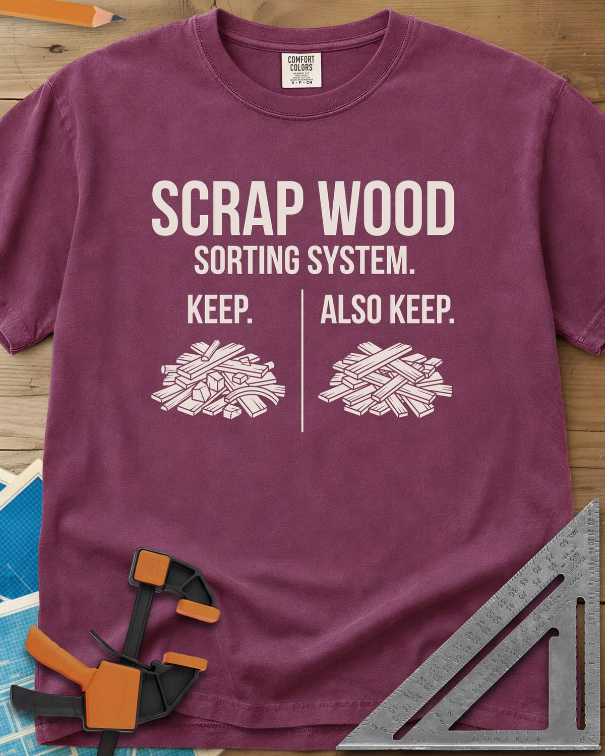 Scrap Wood Sorting System heavyweight tee in Berry, two piles of scrap lumber split by a thin vertical line
