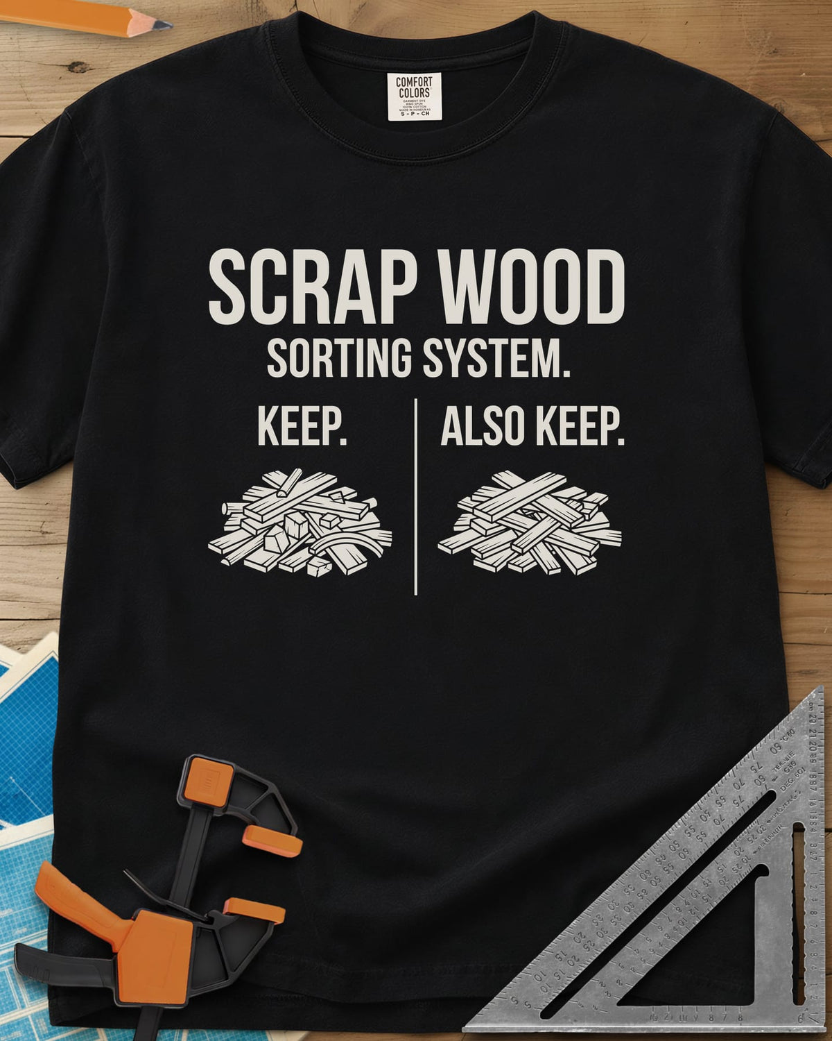 Scrap Wood Sorting System heavyweight tee in Black, two piles of scrap lumber split by a thin vertical line