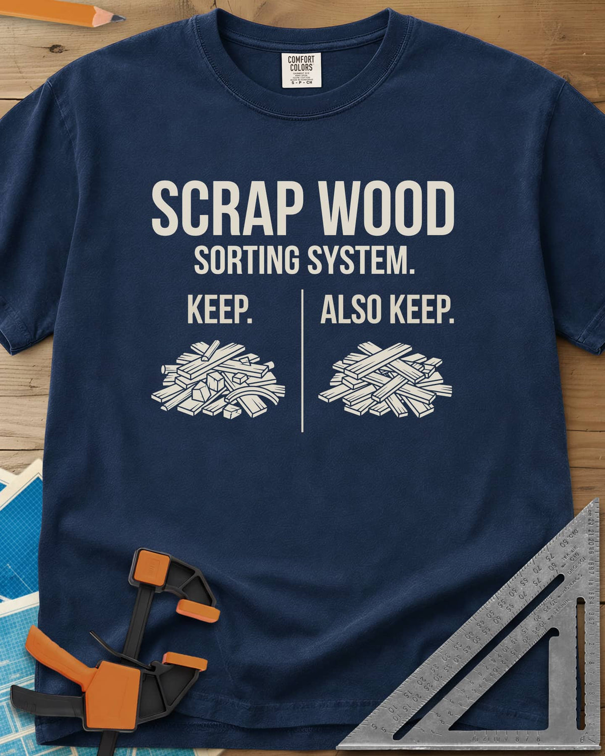 Scrap Wood Sorting System heavyweight tee in Navy, two piles of scrap lumber split by a thin vertical line