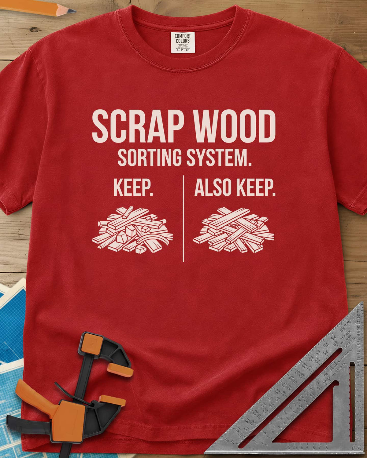 Scrap Wood Sorting System heavyweight tee in Red, two piles of scrap lumber split by a thin vertical line