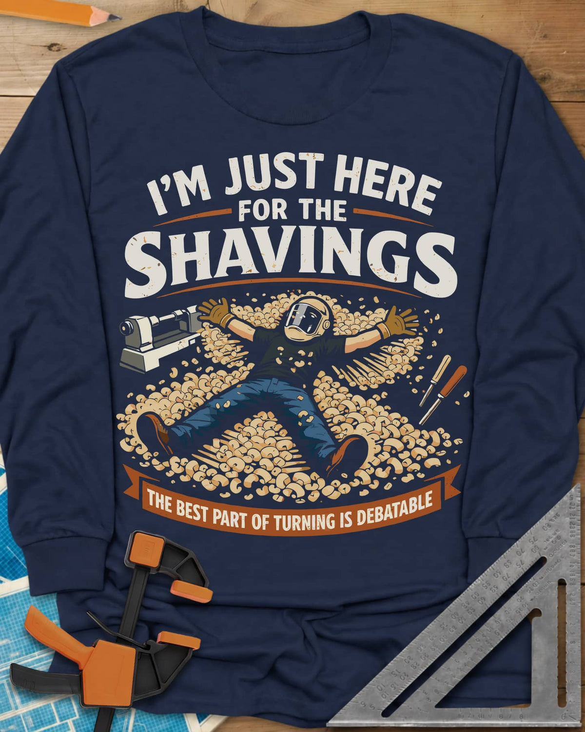 Shavings long sleeve shirt in Navy, a turner in a face shield lying in a drift of wood shavings