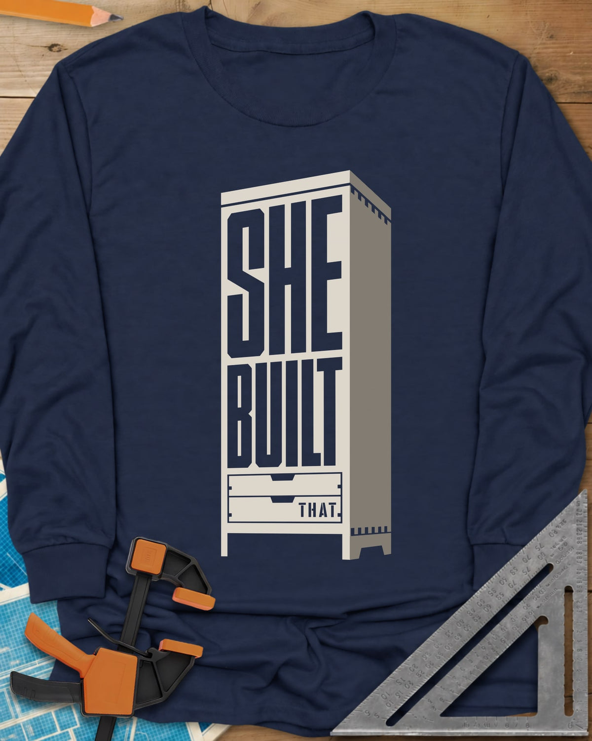 She Built long sleeve shirt in Navy, stacked letters set into a tall cabinet with two drawers