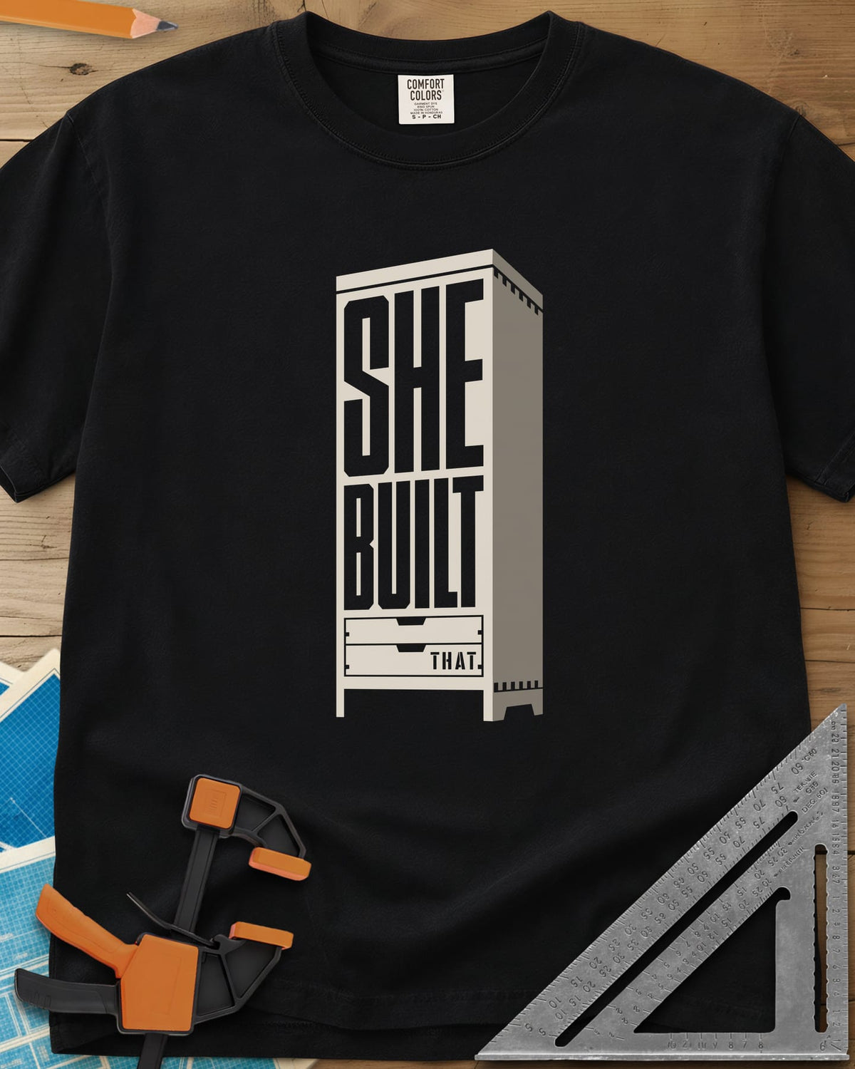 She Built heavyweight tee in Black, stacked letters set into a tall cabinet with two drawers