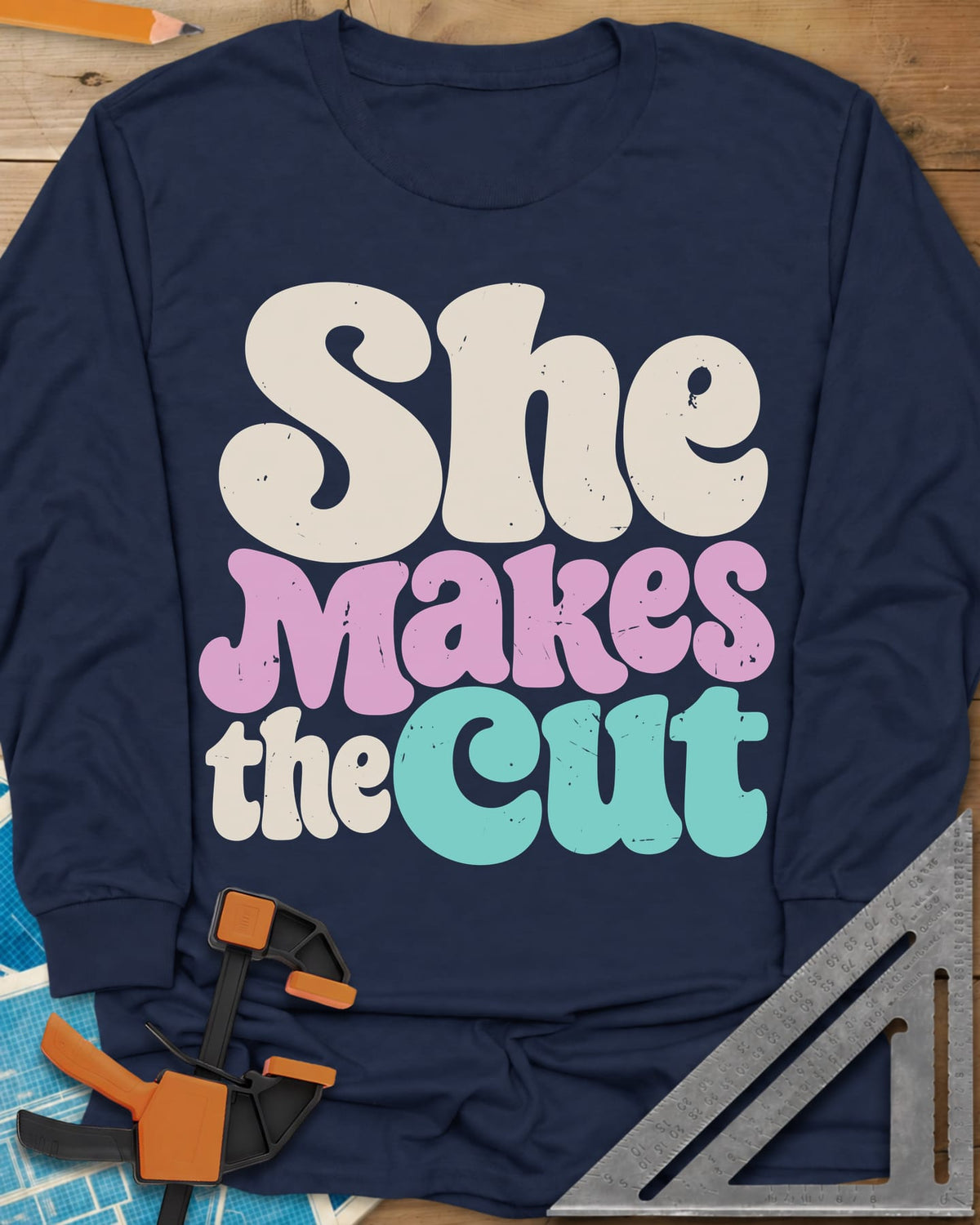 She Makes The Cut long sleeve shirt in Navy, chunky retro lettering in cream, pink and teal