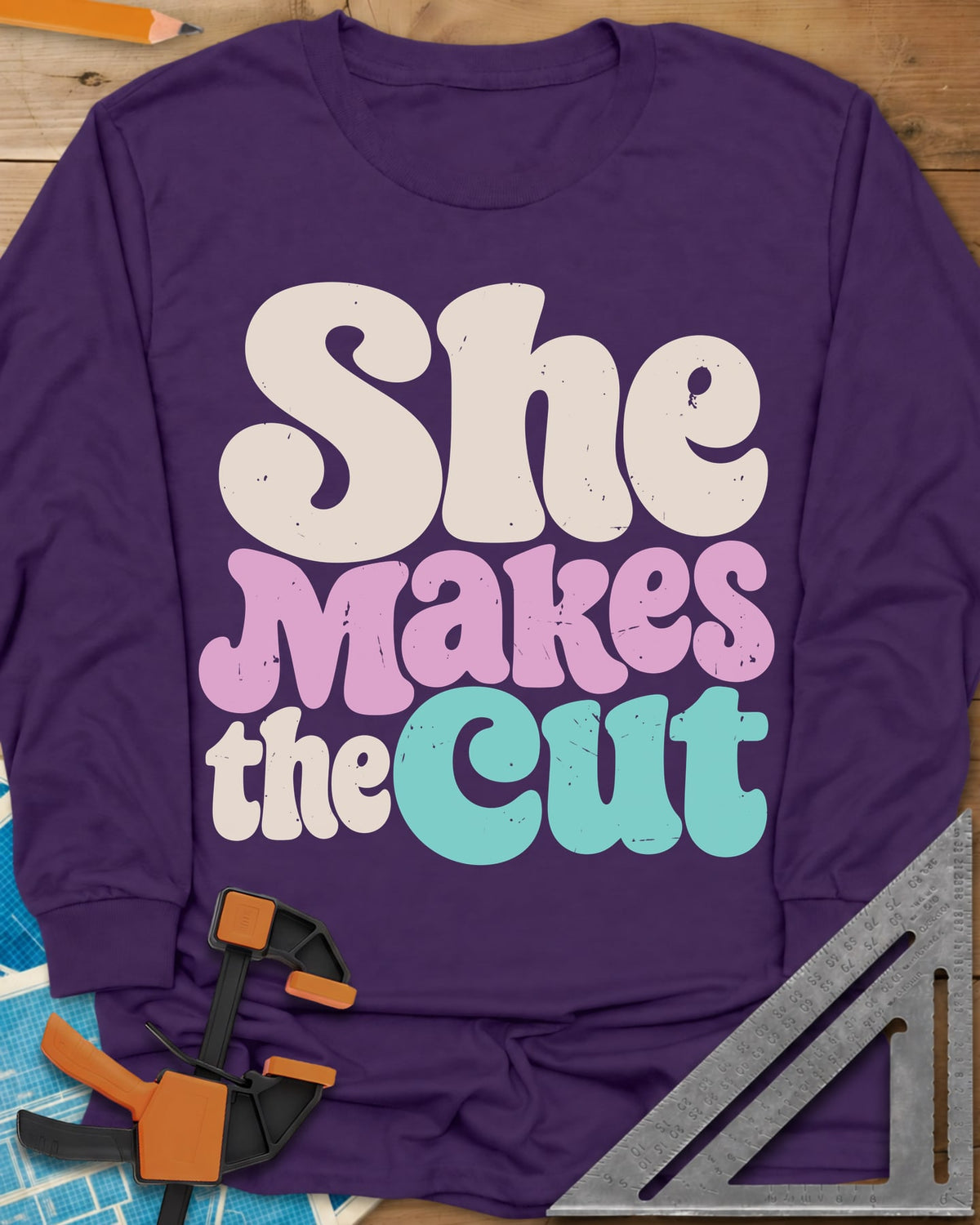 She Makes The Cut long sleeve shirt in Purple, chunky retro lettering in cream, pink and teal