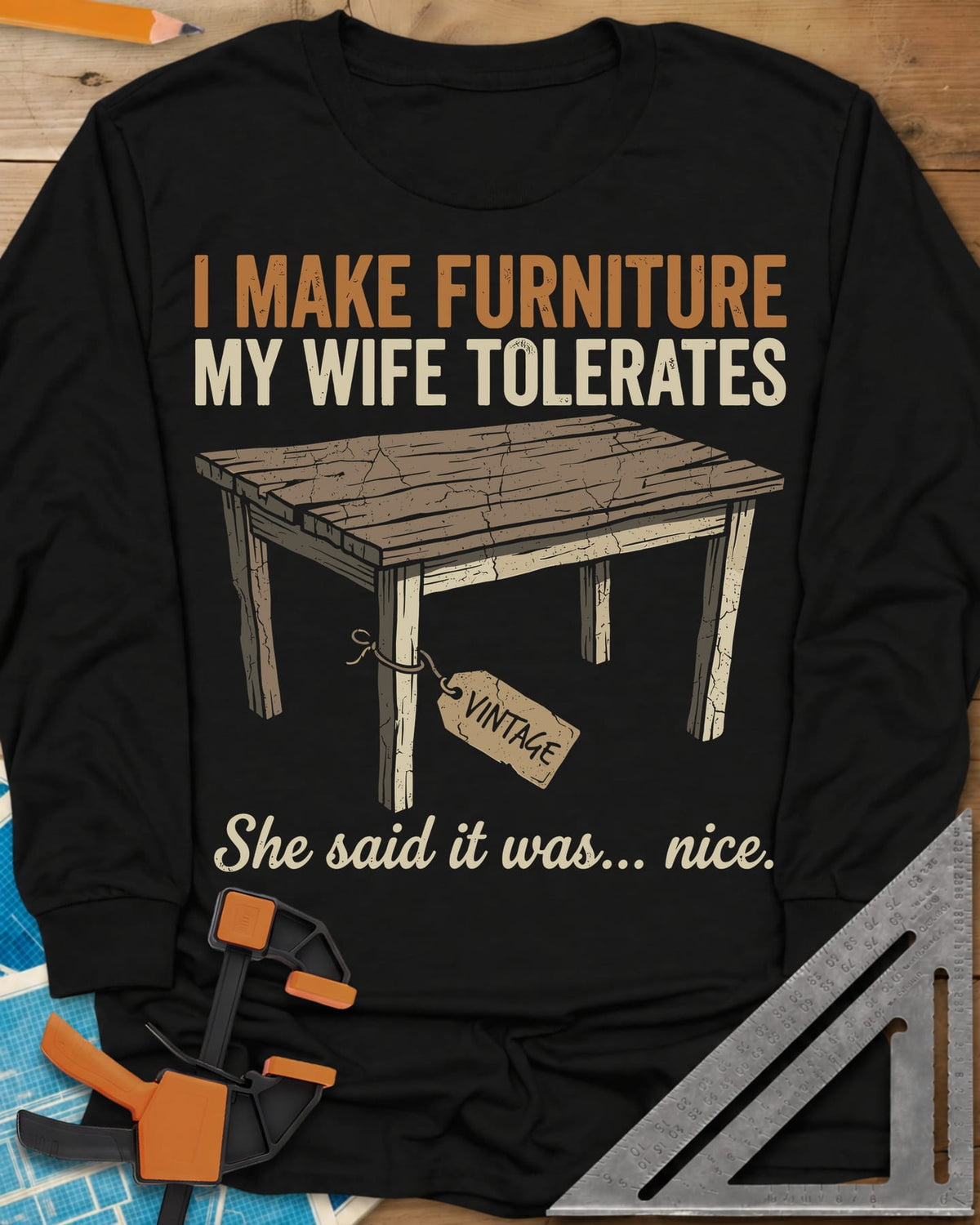 She Said It Was Nice long sleeve shirt in Black, a weathered rustic table with a VINTAGE tag tied to one leg