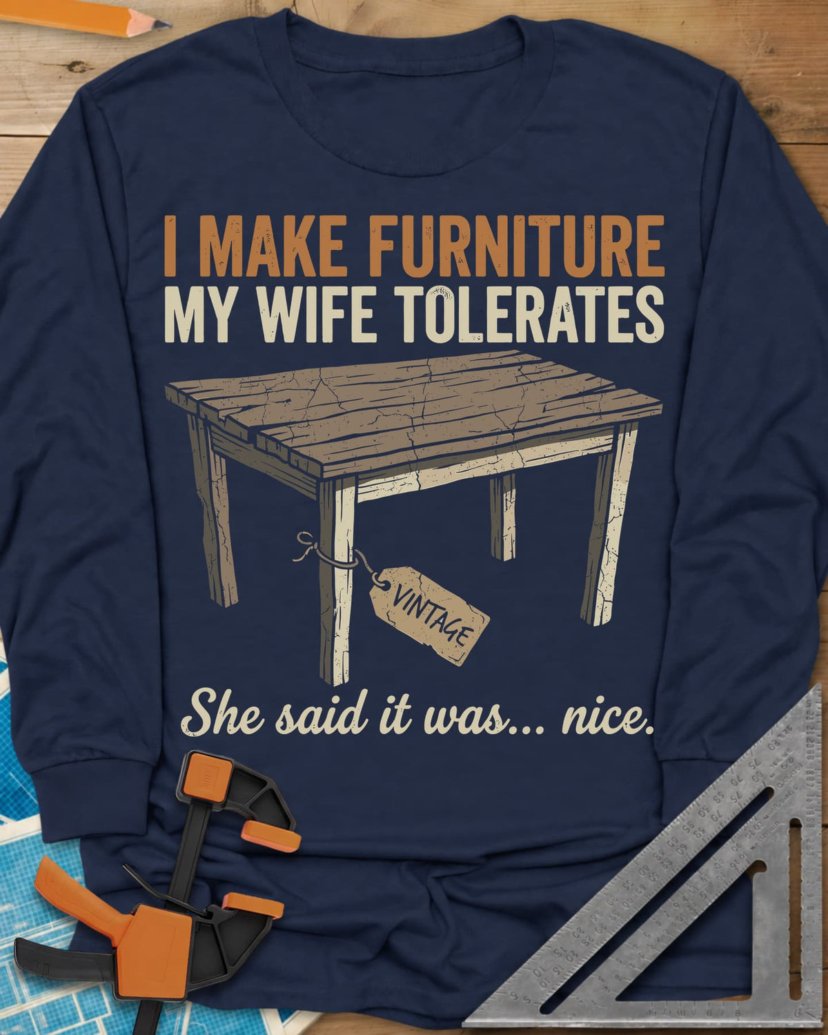 She Said It Was Nice long sleeve shirt in Navy, a weathered rustic table with a VINTAGE tag tied to one leg