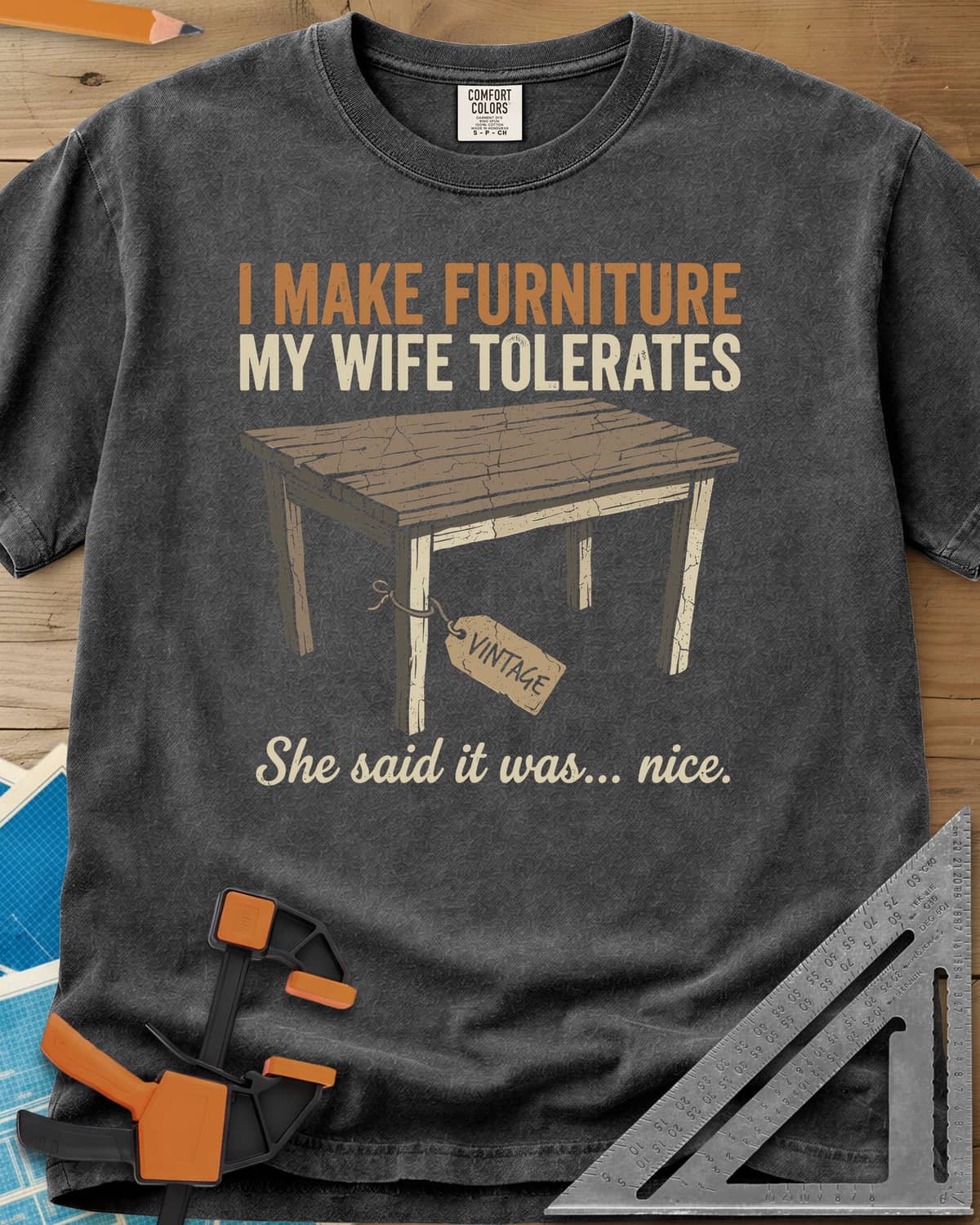 She Said It Was Nice heavyweight tee in Pepper, a weathered rustic table with a VINTAGE tag tied to one leg