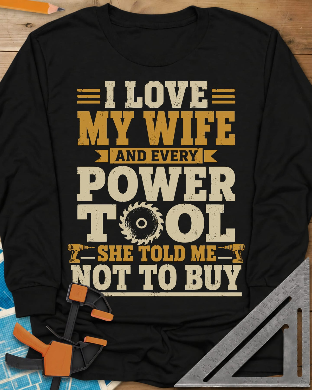 She Told Me Not To Buy Power Tools long sleeve shirt in Black, stacked lettering with a saw blade for the O and two cordless