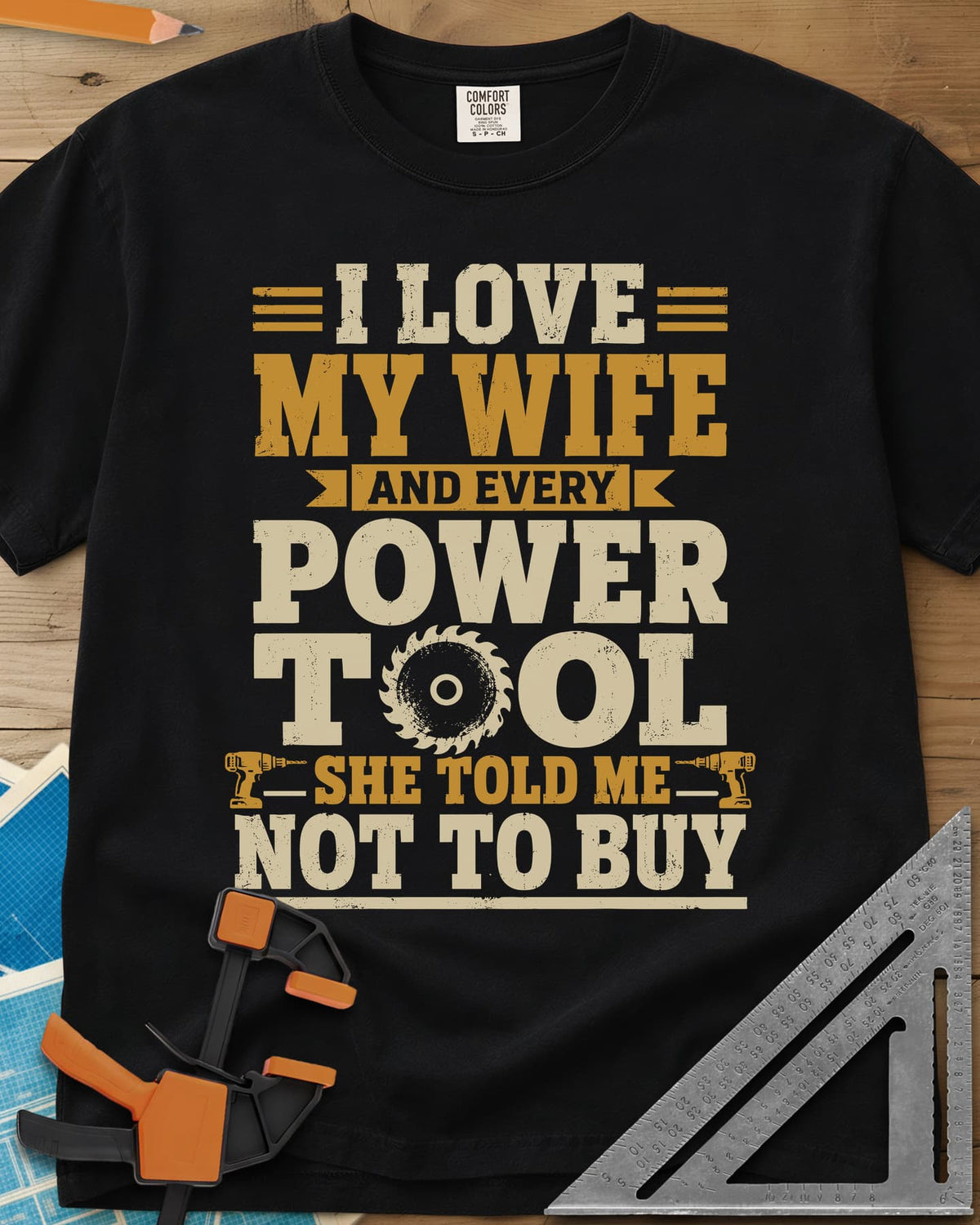 She Told Me Not To Buy Power Tools heavyweight tee in Black, stacked lettering with a saw blade for the O and two cordless