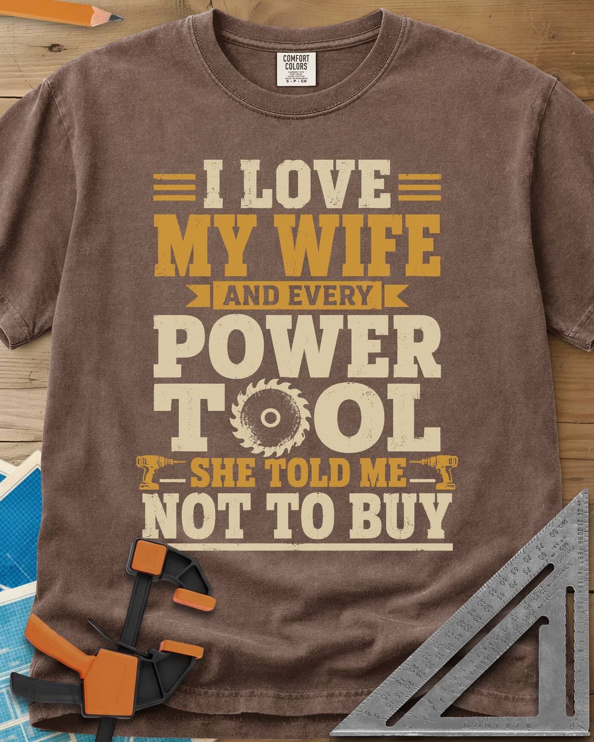 She Told Me Not To Buy Power Tools heavyweight tee in Espresso, stacked lettering with a saw blade for the O and two