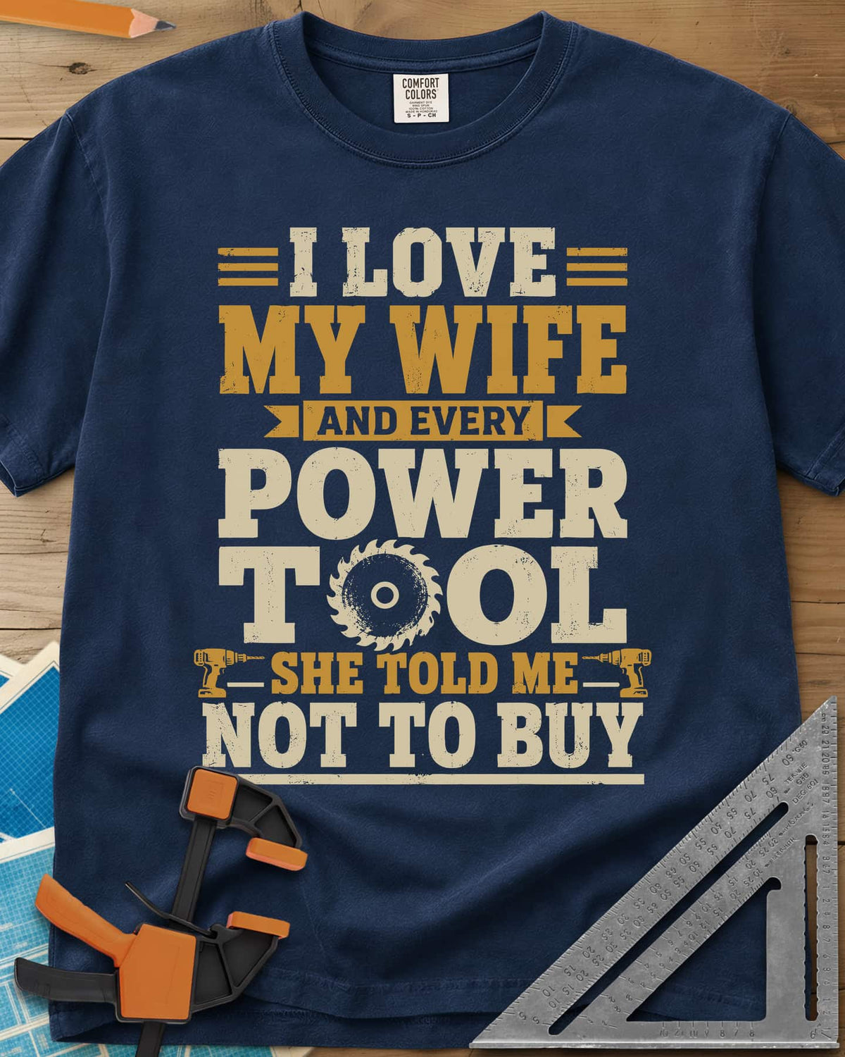 She Told Me Not To Buy Power Tools heavyweight tee in Navy, stacked lettering with a saw blade for the O and two cordless