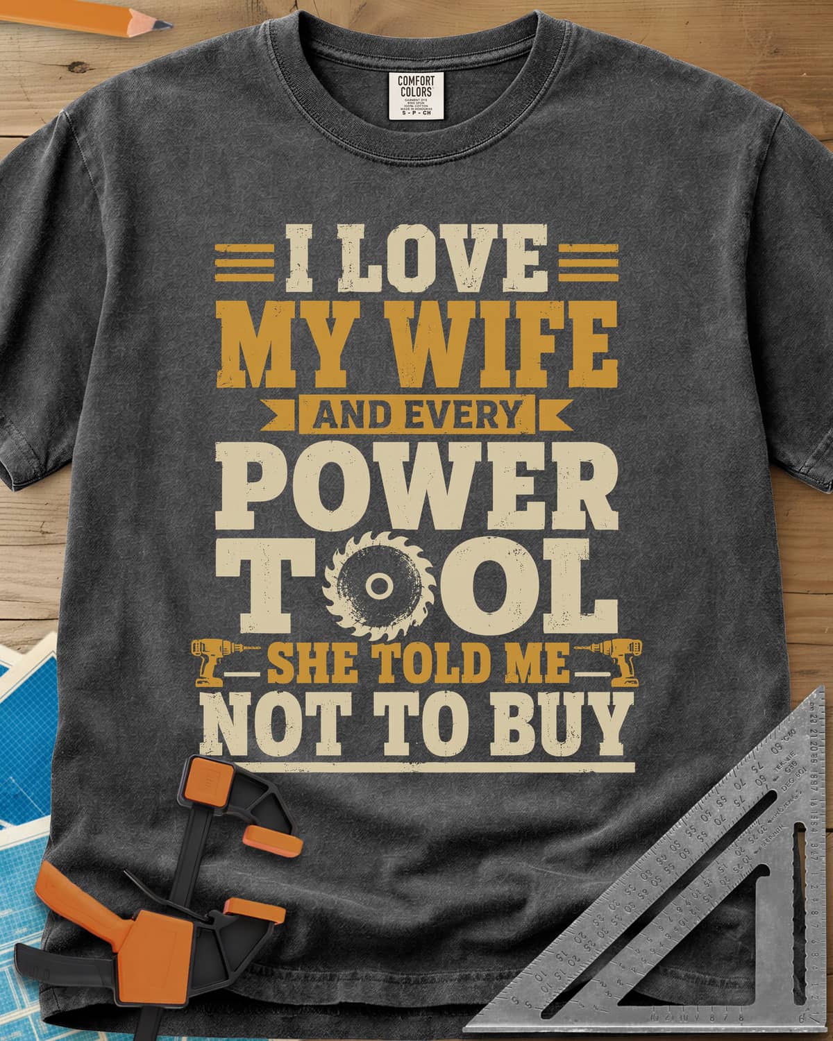 She Told Me Not To Buy Power Tools heavyweight tee in Pepper, stacked lettering with a saw blade for the O and two cordless