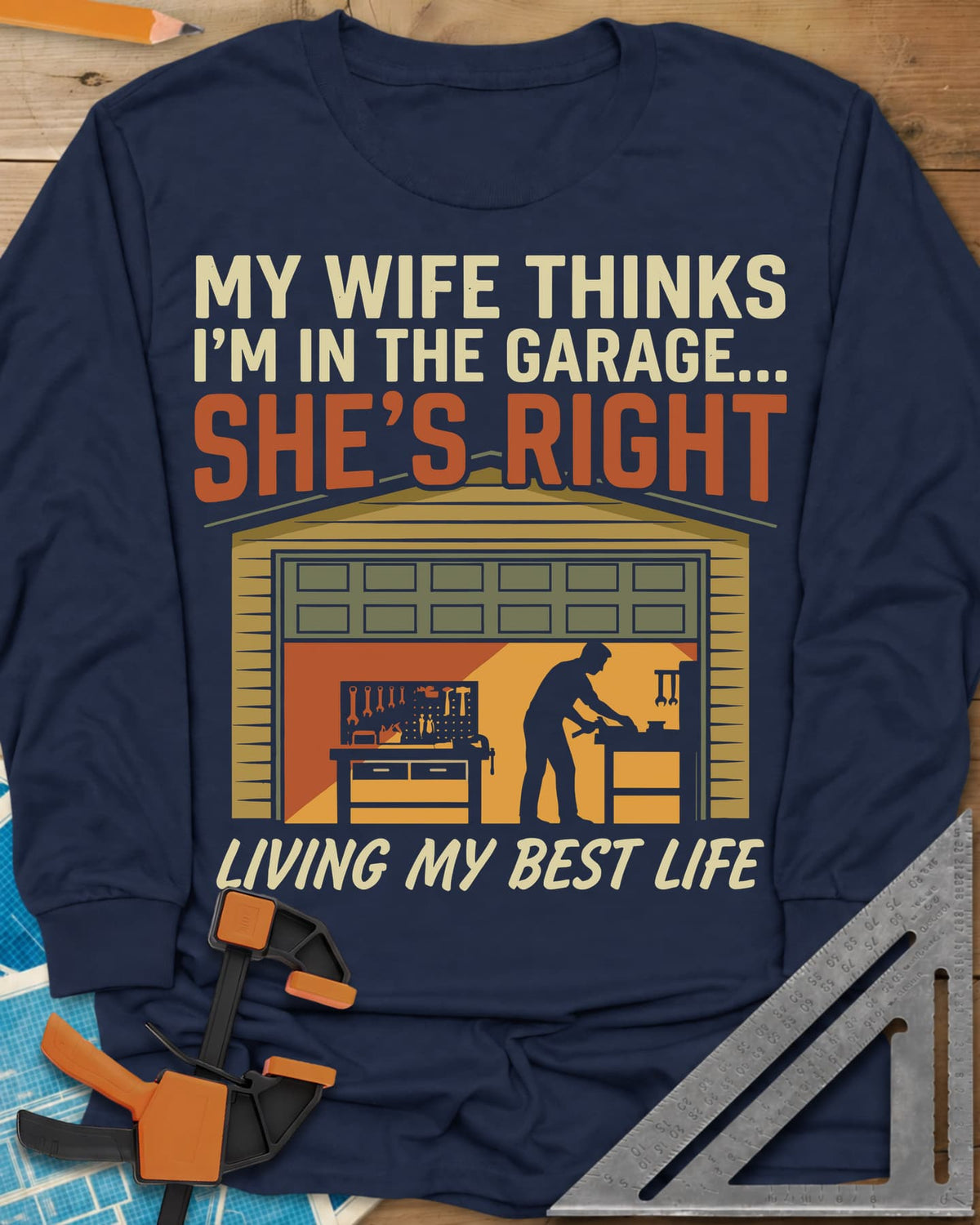 She’s Right long sleeve shirt in Navy, a man at his workbench in an open garage, tools on a pegboard