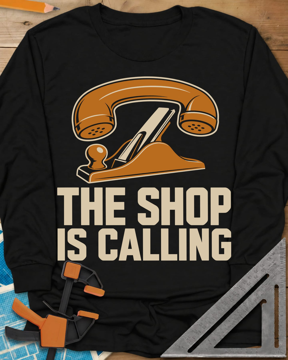Shop Calling long sleeve shirt in Black, an old telephone handset resting on a hand plane