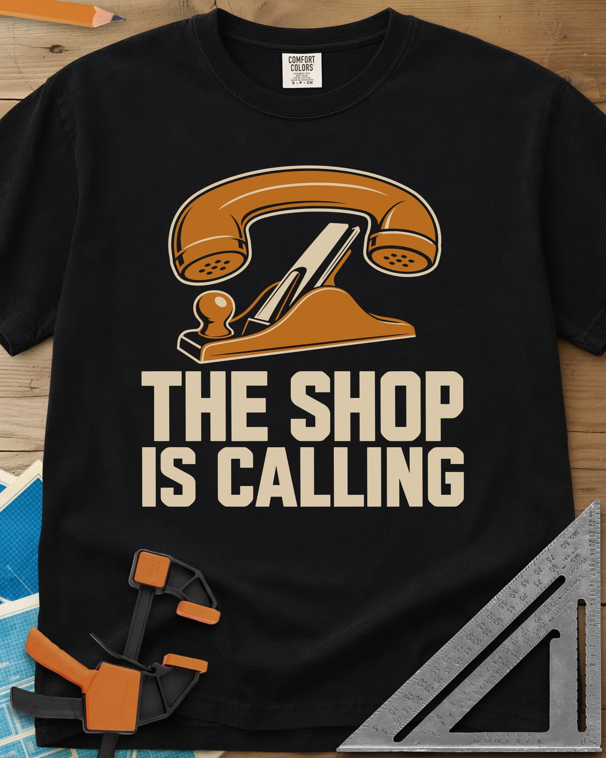 Shop Calling heavyweight tee in Black, an old telephone handset resting on a hand plane
