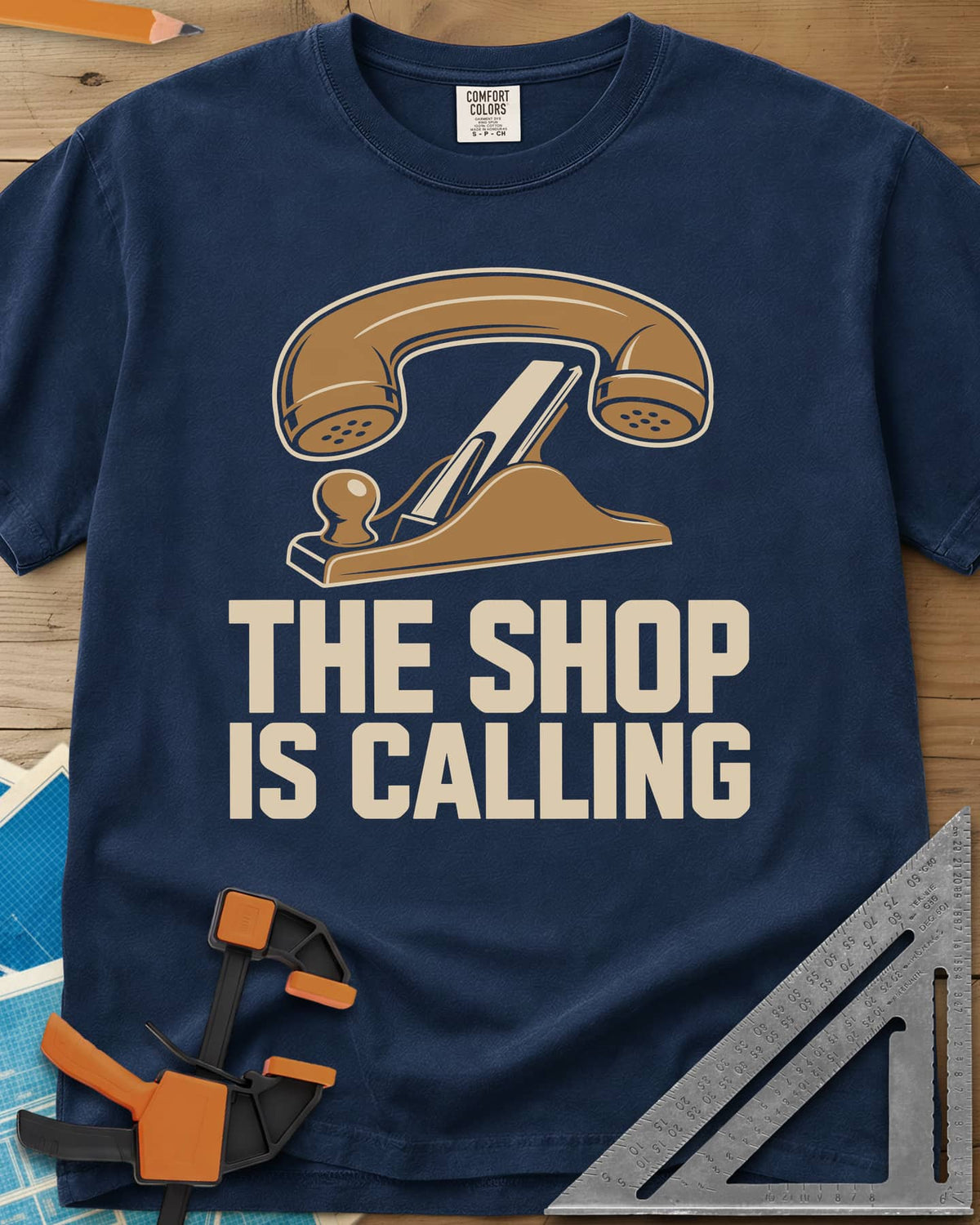 Shop Calling heavyweight tee in Navy, an old telephone handset resting on a hand plane