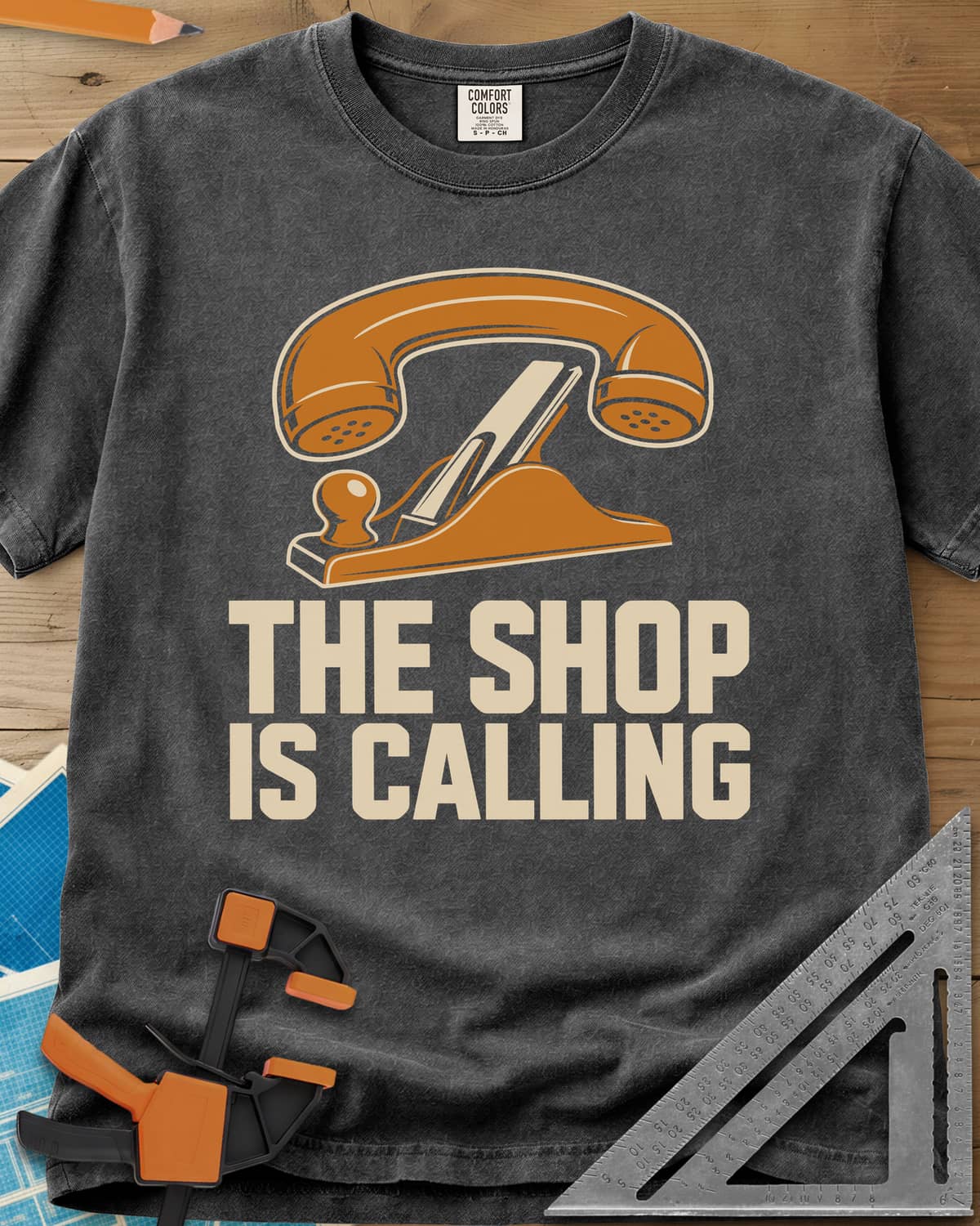 Shop Calling heavyweight tee in Pepper, an old telephone handset resting on a hand plane