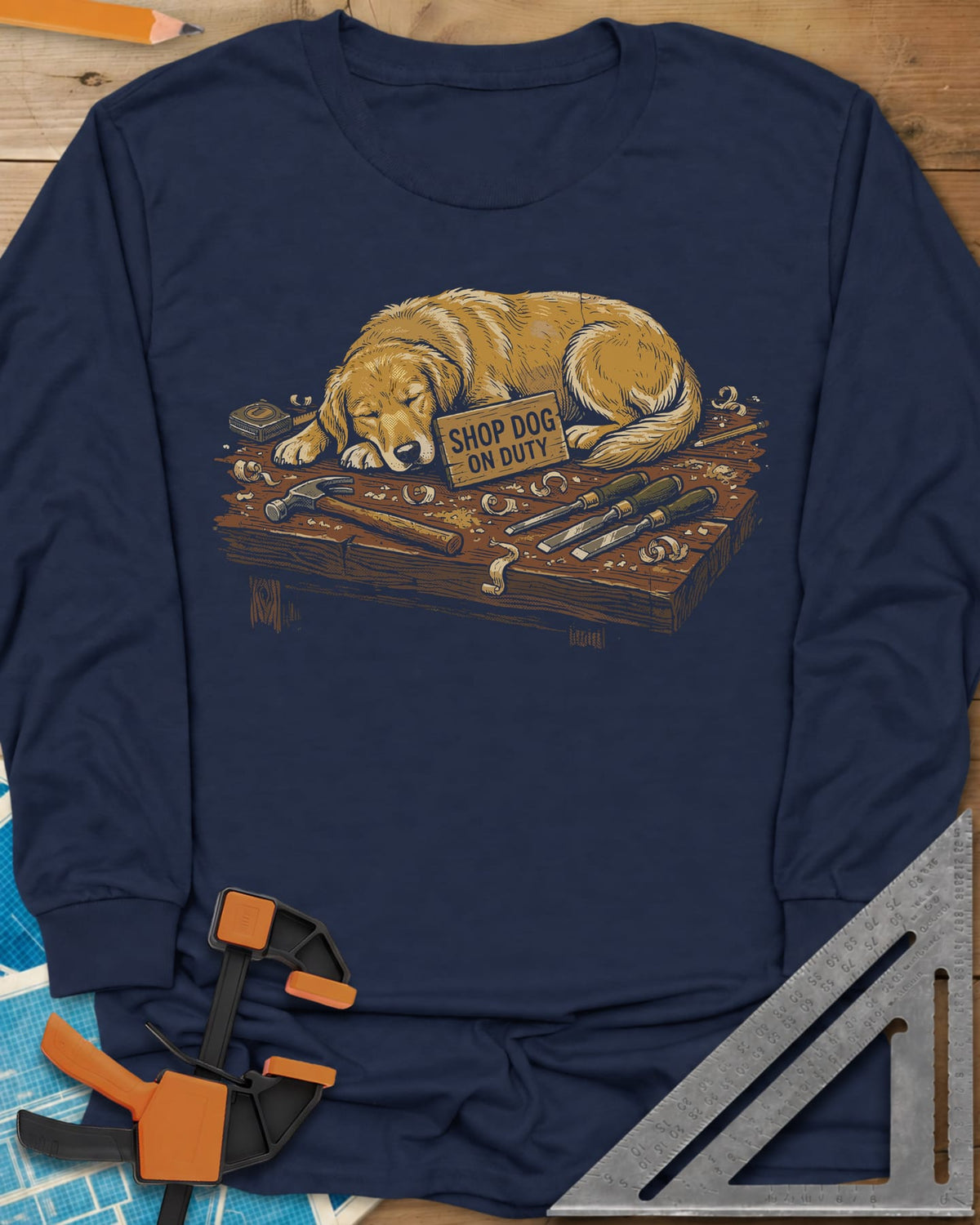 Shop Dog On Duty long sleeve shirt in Navy, a golden retriever asleep on a workbench beside tools and shavings
