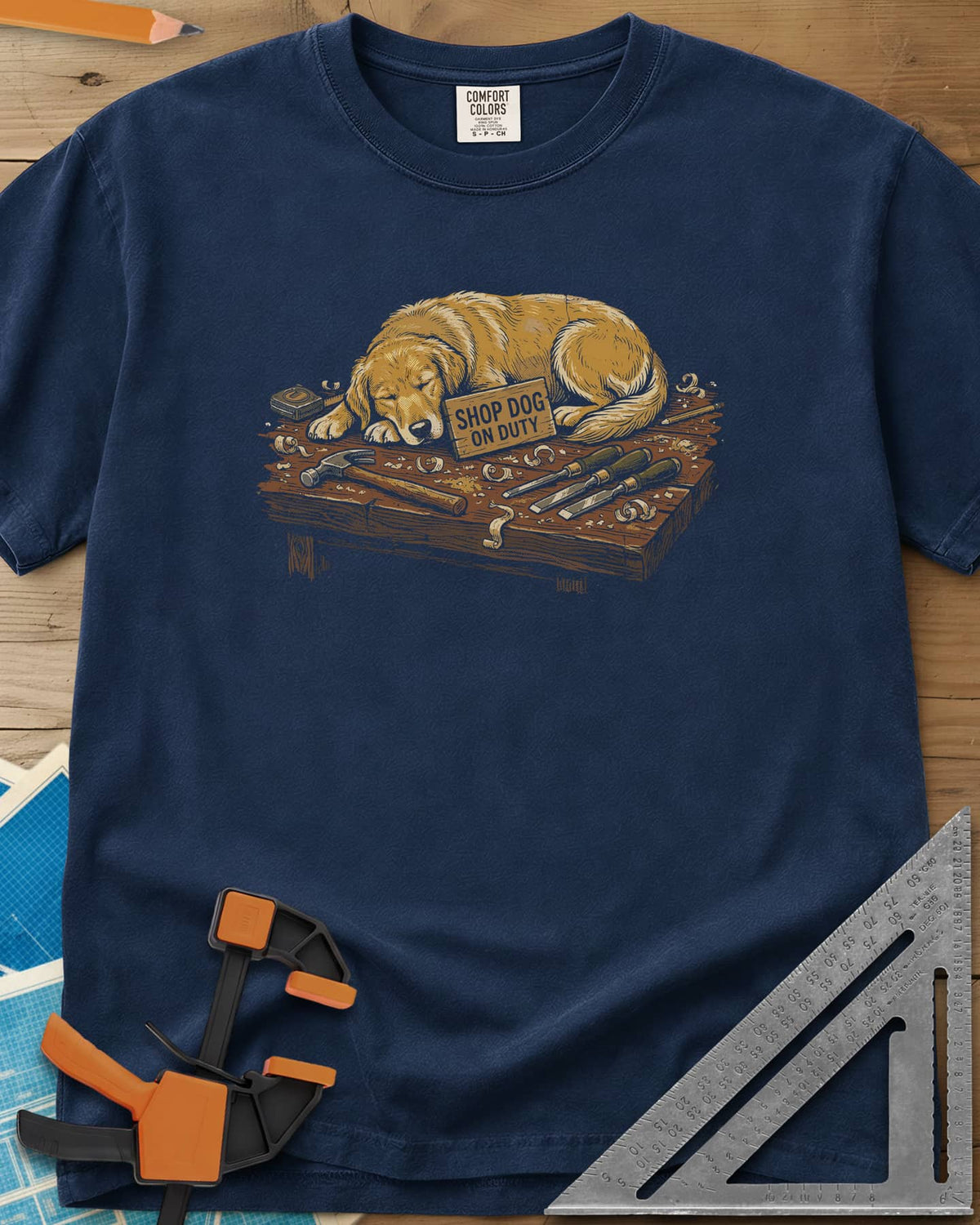 Shop Dog On Duty heavyweight tee in Navy, a golden retriever asleep on a workbench beside tools and shavings