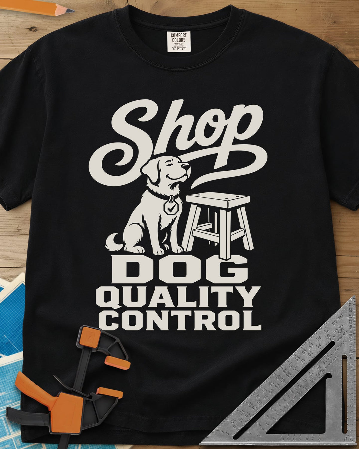 Shop Dog heavyweight tee in Black, a seated dog with a check-mark tag beside a shop stool