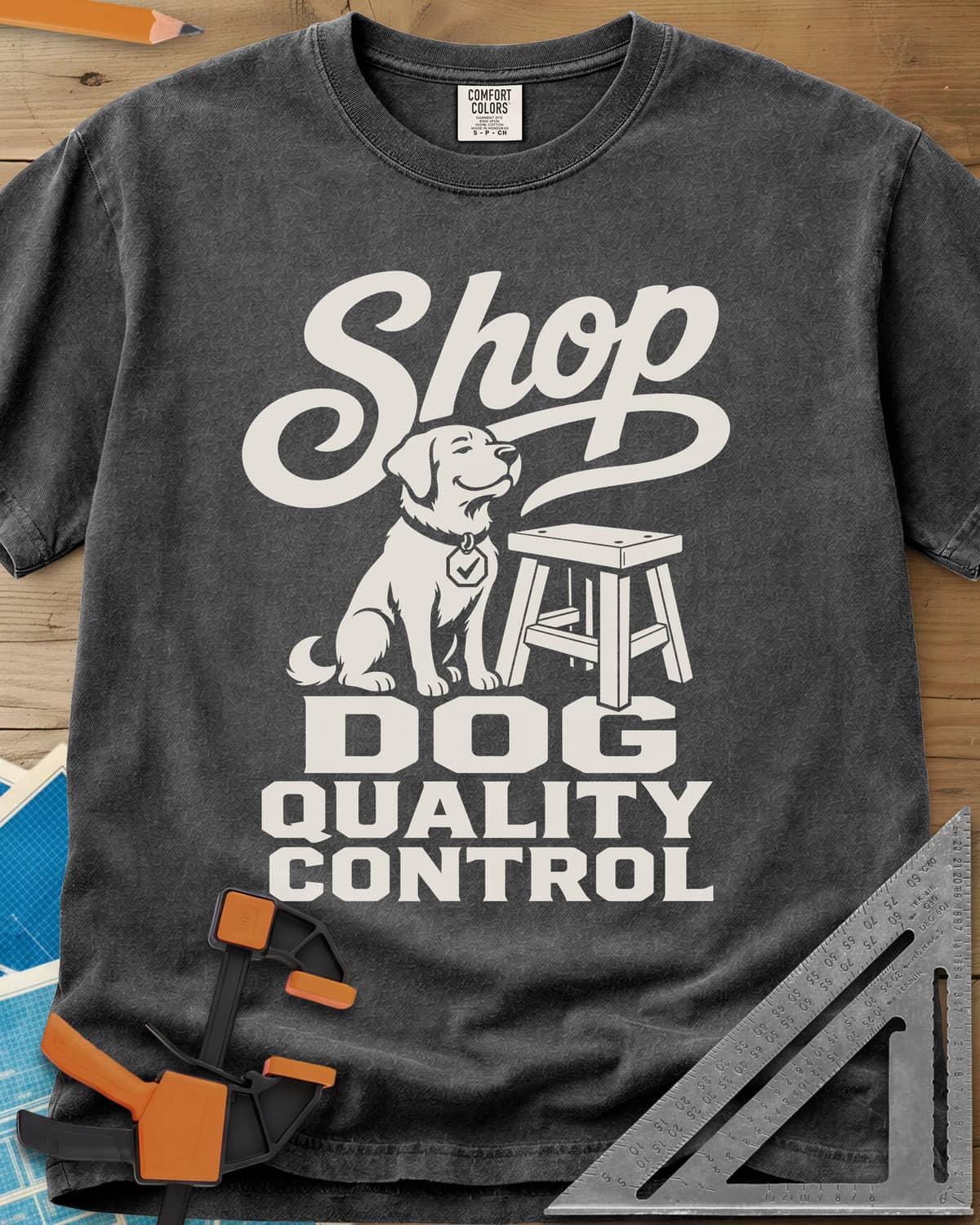 Shop Dog heavyweight tee in Pepper, a seated dog with a check-mark tag beside a shop stool