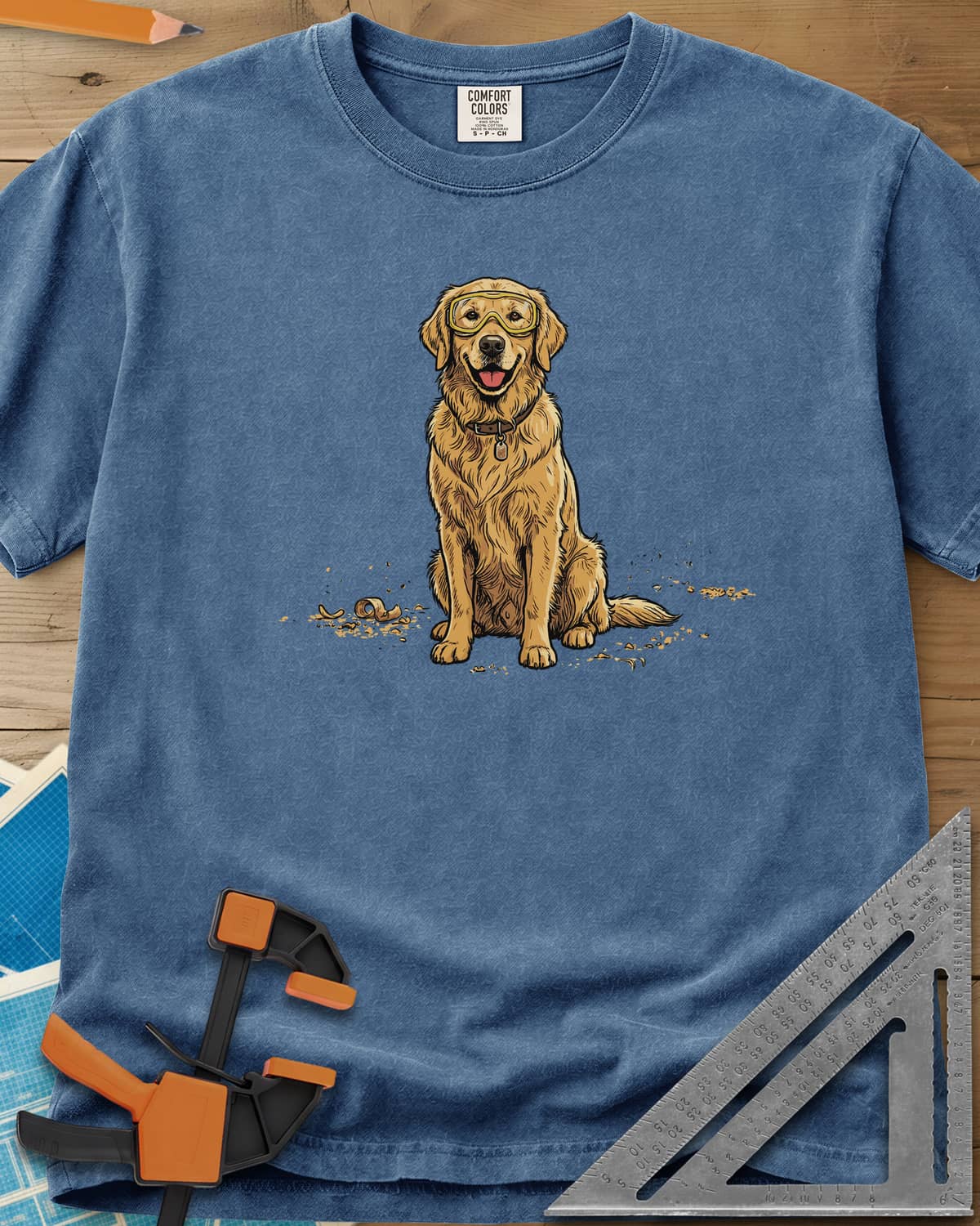 Shop Dog Safety First heavyweight tee in Blue Jean, a golden retriever in safety goggles sitting in wood shavings