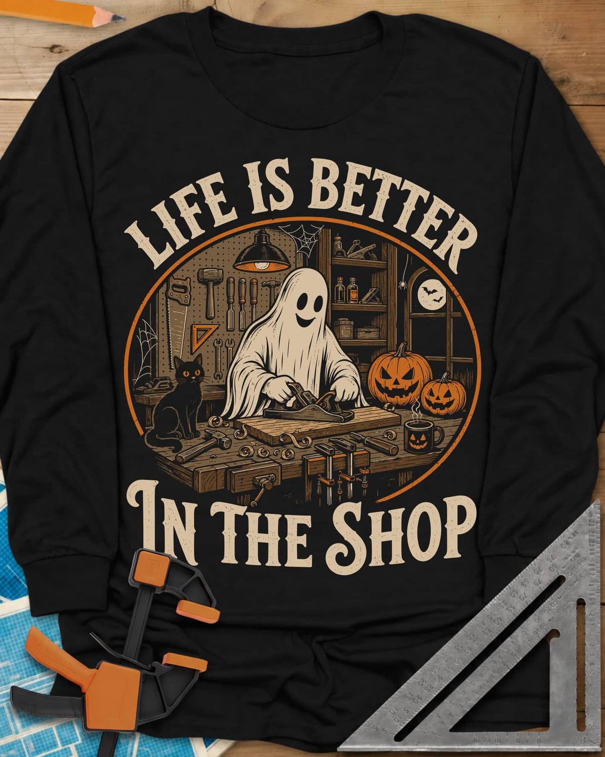 Shop Life long sleeve shirt in Black, a smiling ghost planing a board beside a cat and pumpkins