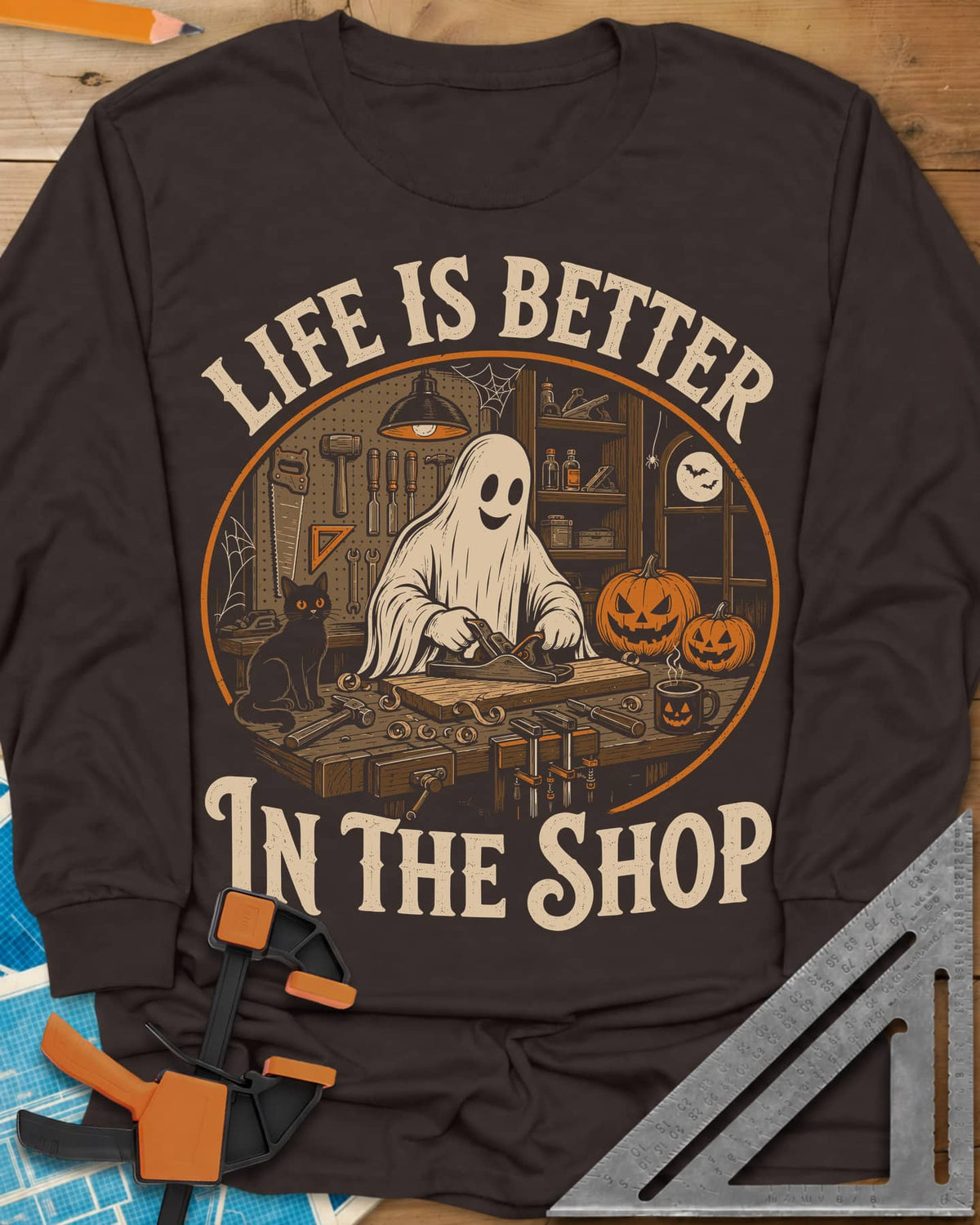 Shop Life long sleeve shirt in Dark Chocolate, a smiling ghost planing a board beside a cat and pumpkins