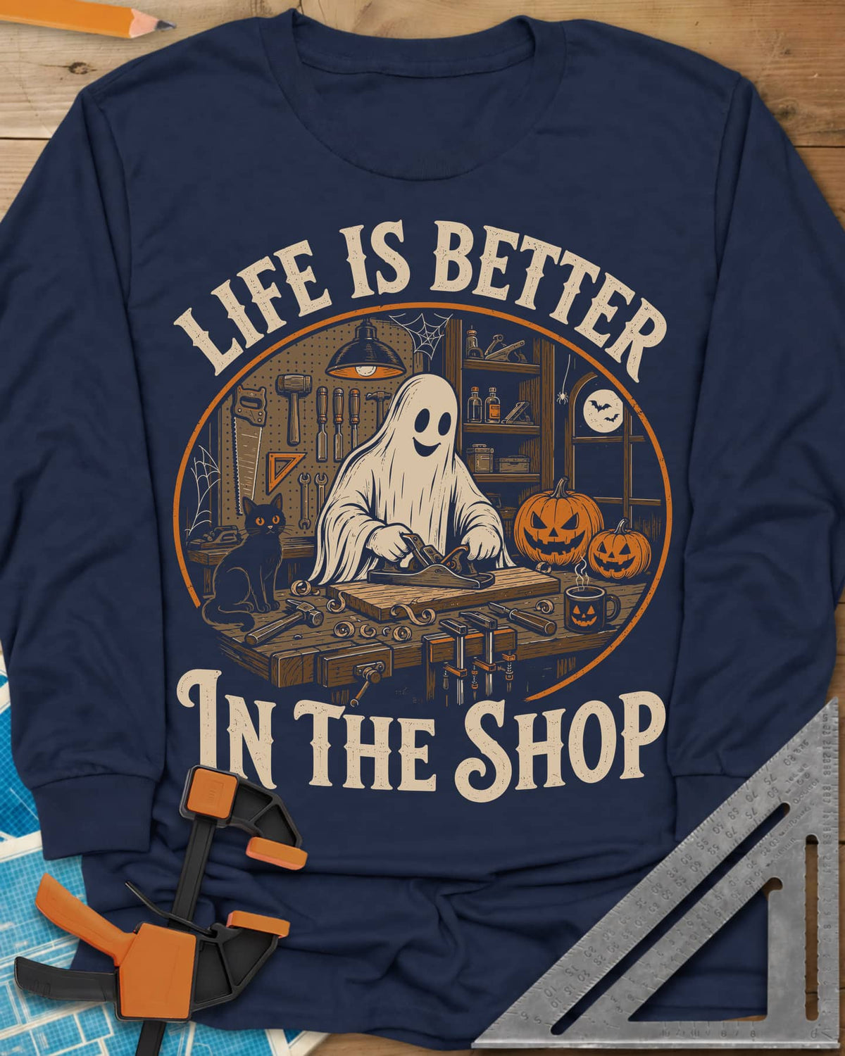 Shop Life long sleeve shirt in Navy, a smiling ghost planing a board beside a cat and pumpkins